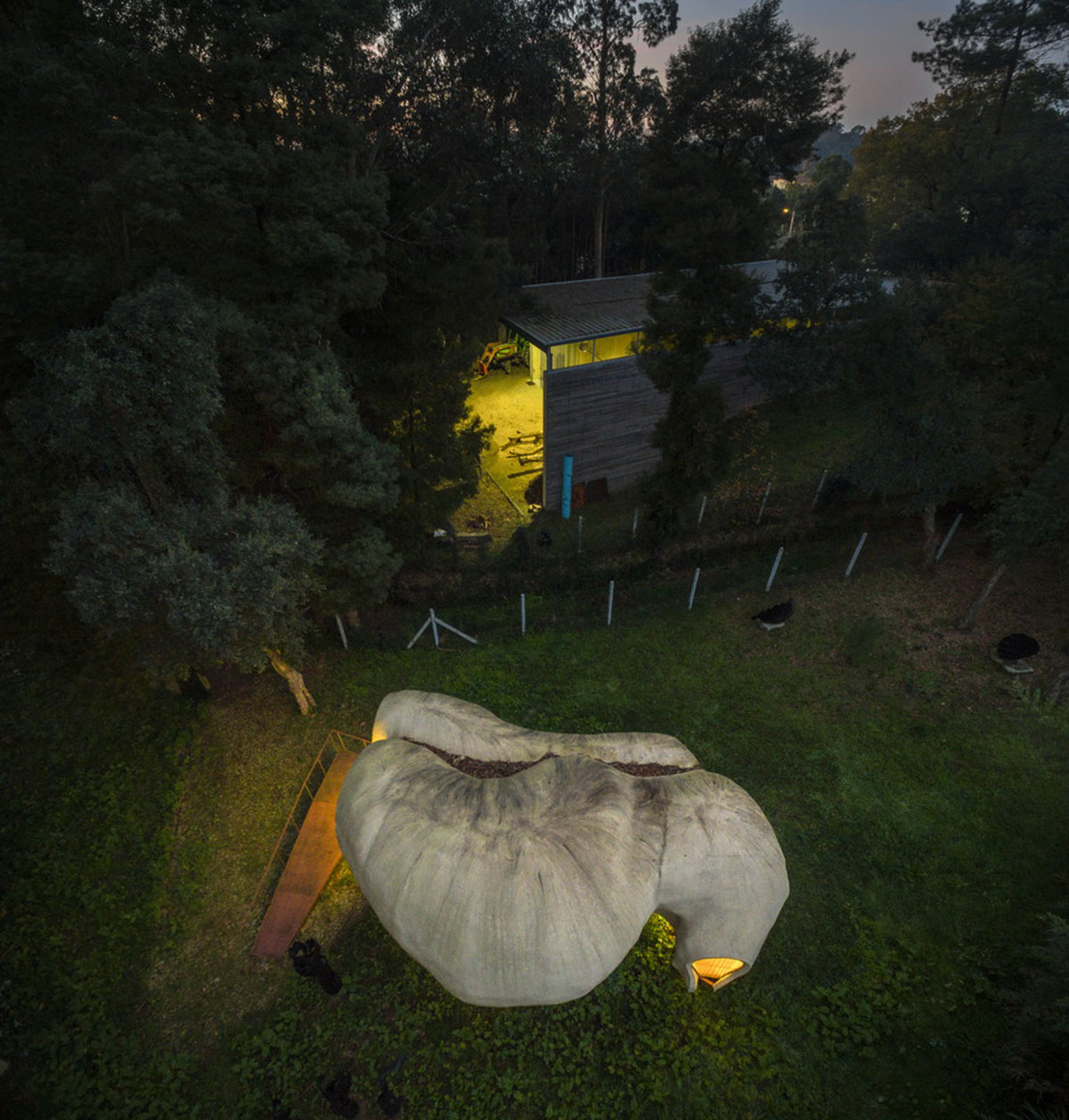 Super small cave-like art gallery by FCC Arquitectura built on lush green in Portugal