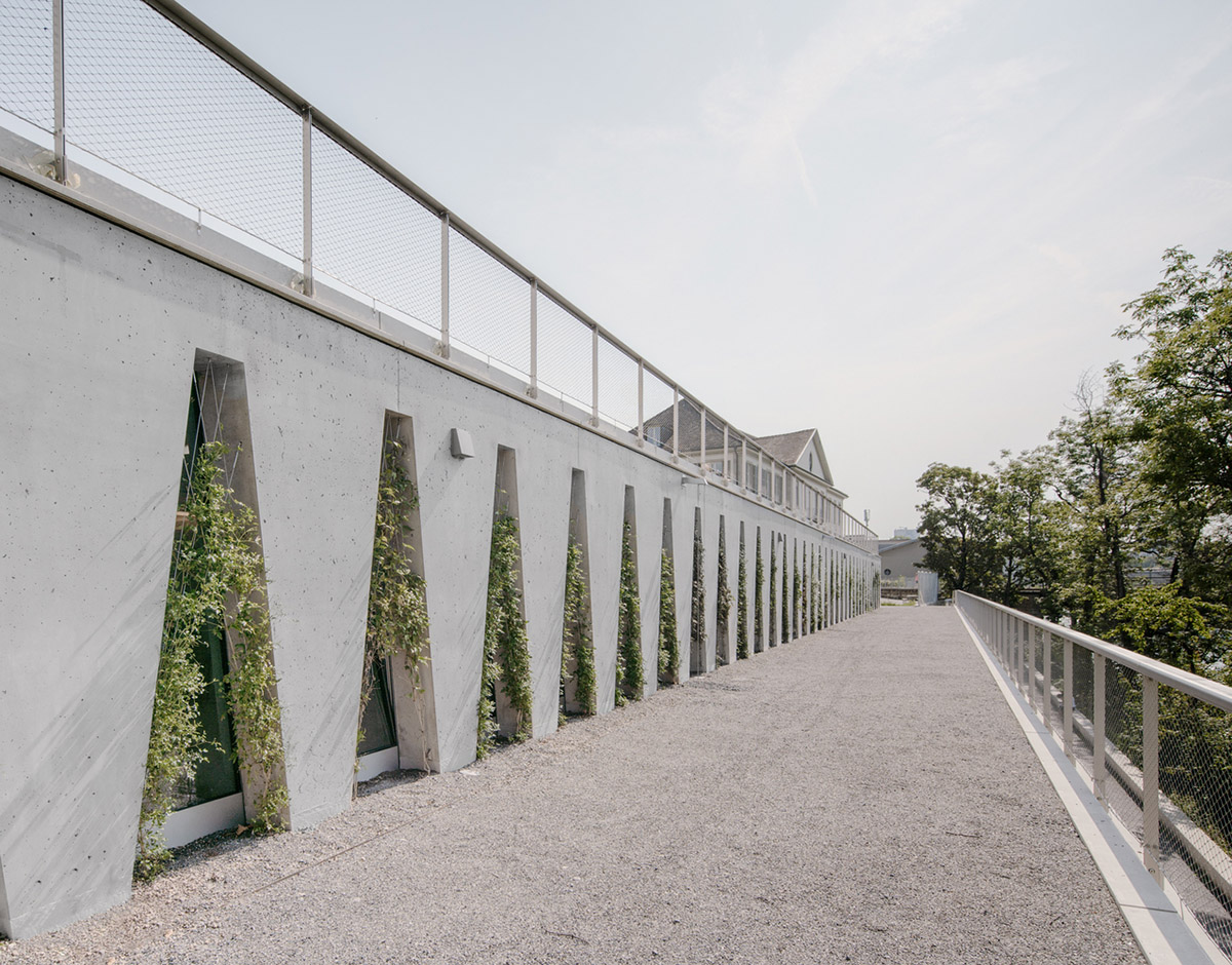 Trapezoidal openings characterize the interiors of cultural center by Estudio Barozzi Veiga in Zürich