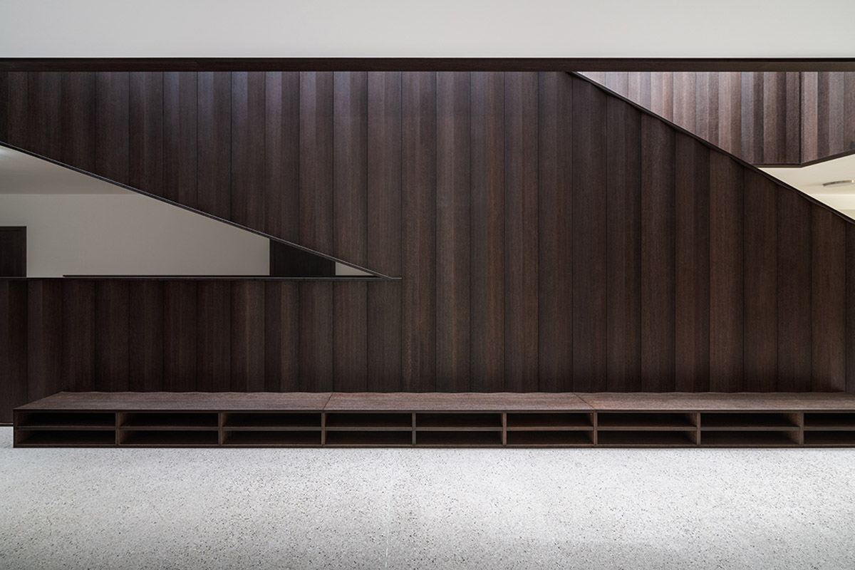 Carlana Mezzalira Pentimalli built music school with cut out and red-pigmented volumes in Italy