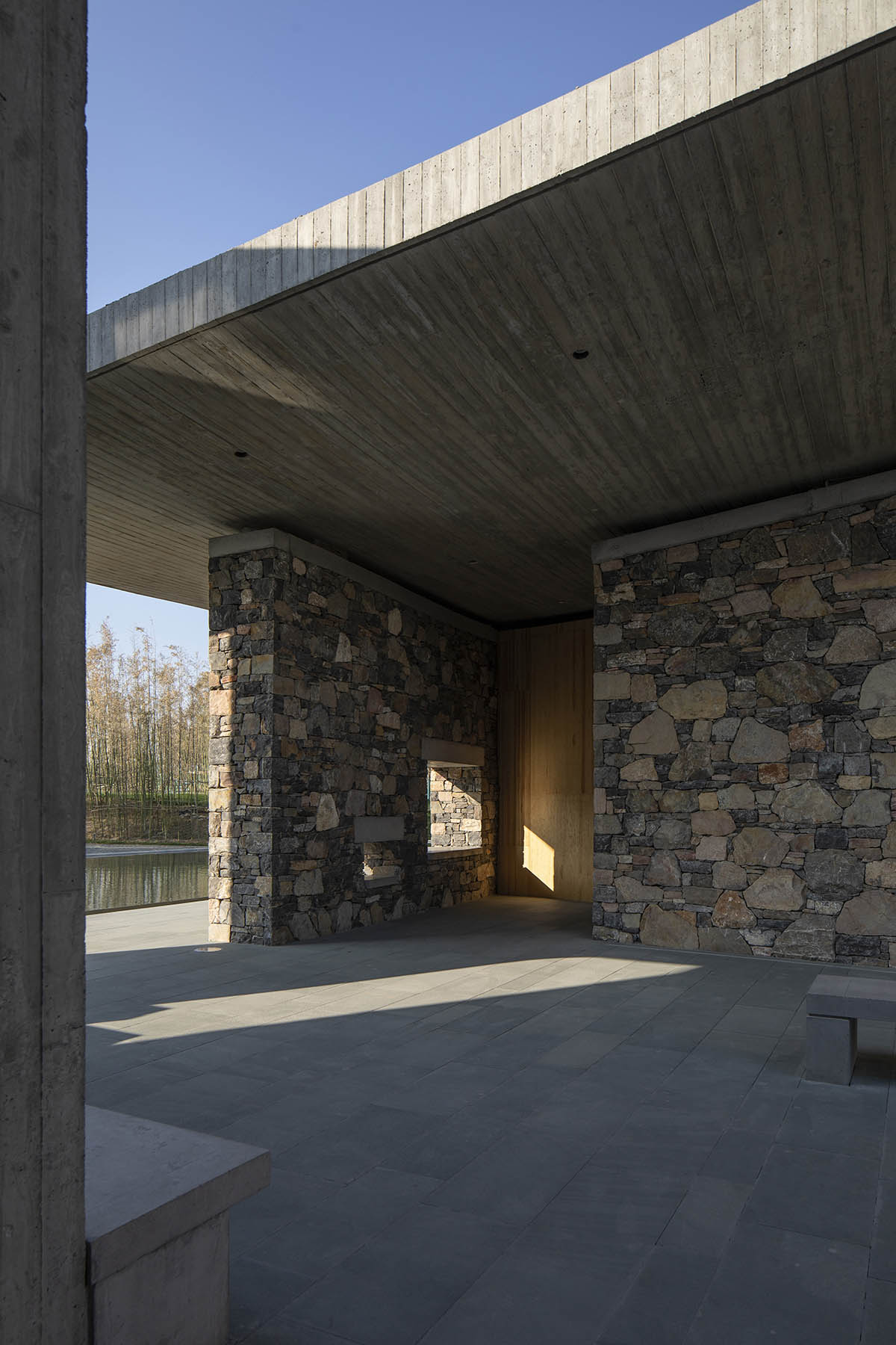 Concrete hyperboloid roofs cover masonry stone art center with a central courtyard in Shandong
