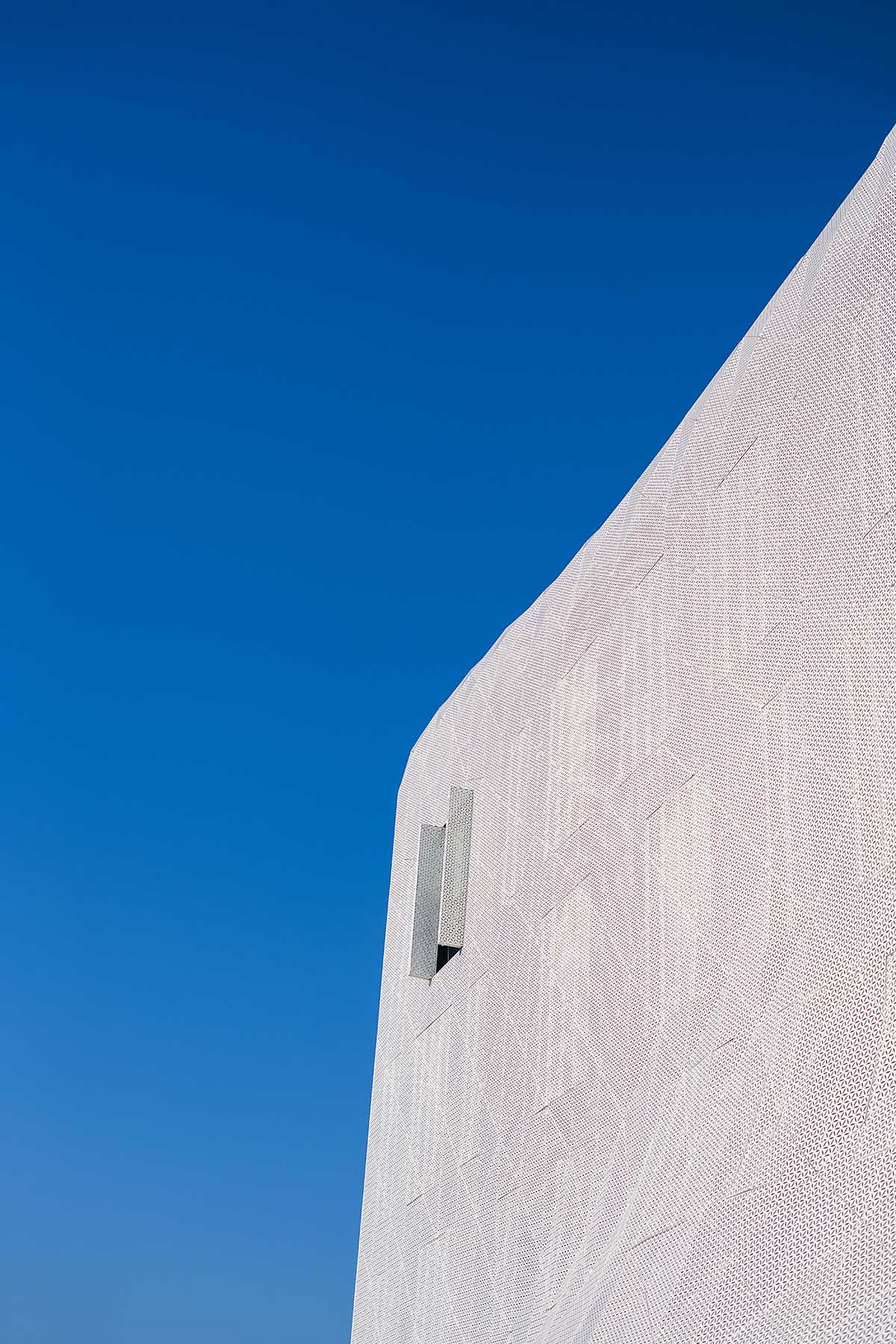 FAAB wraps research center with white perforated facade evoking sea waves in Poland 