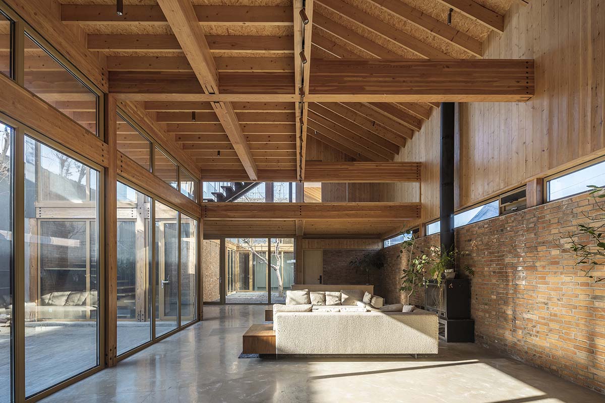 Archstudio renovates traditional Beijing courtyard house with interwoven wooden framework