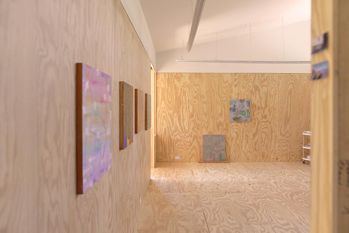 An artist's studio floats and illuminates in the landscape in Germantown