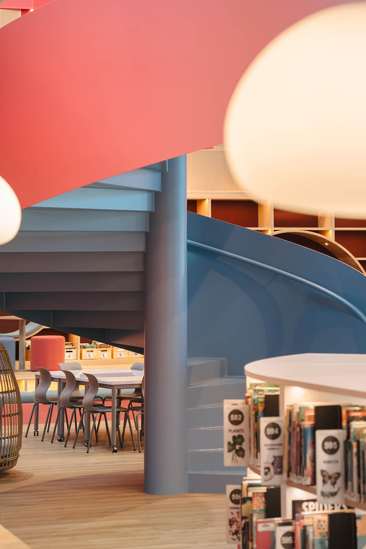 Elementary school library features vibrant colors and playful elements, resembling a fairy tale 