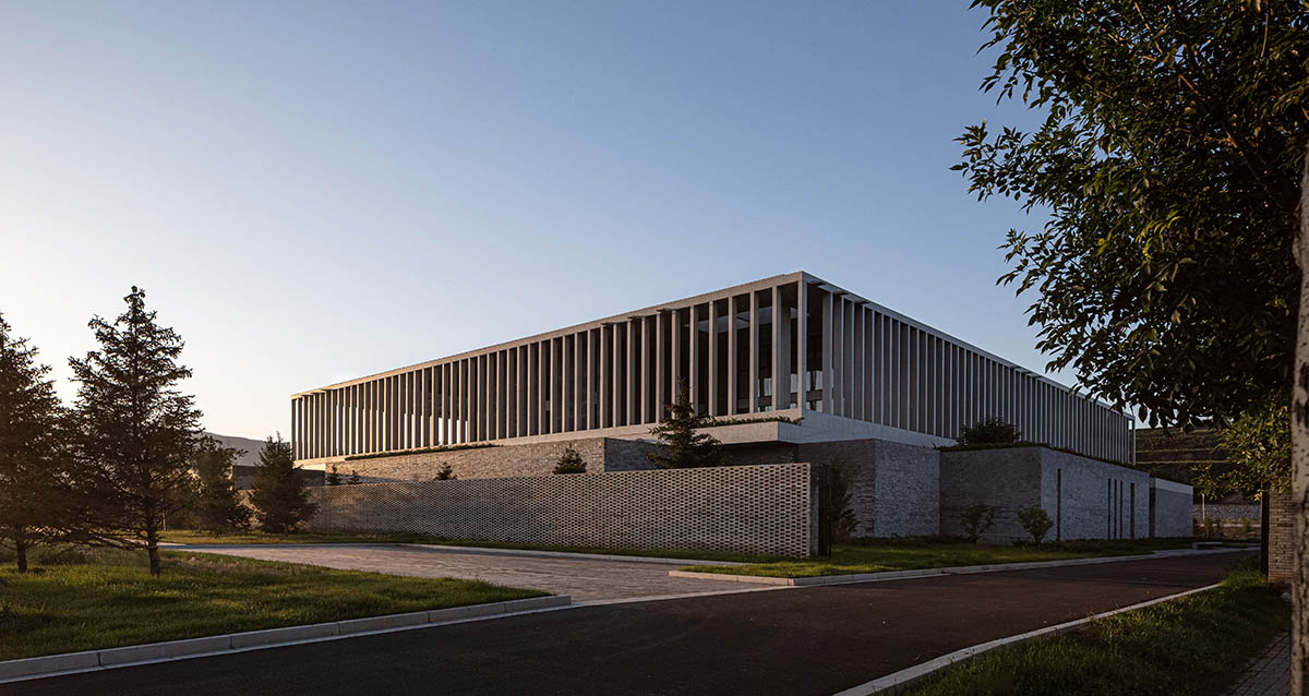 Grey brick walls wrap a factory building referencing to local construction methods in China 