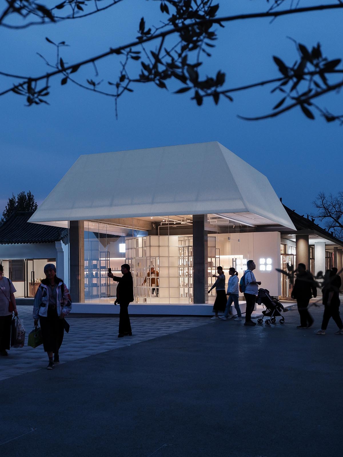 A shop is attached to Beijing historic Hutong houses with white-colored skin