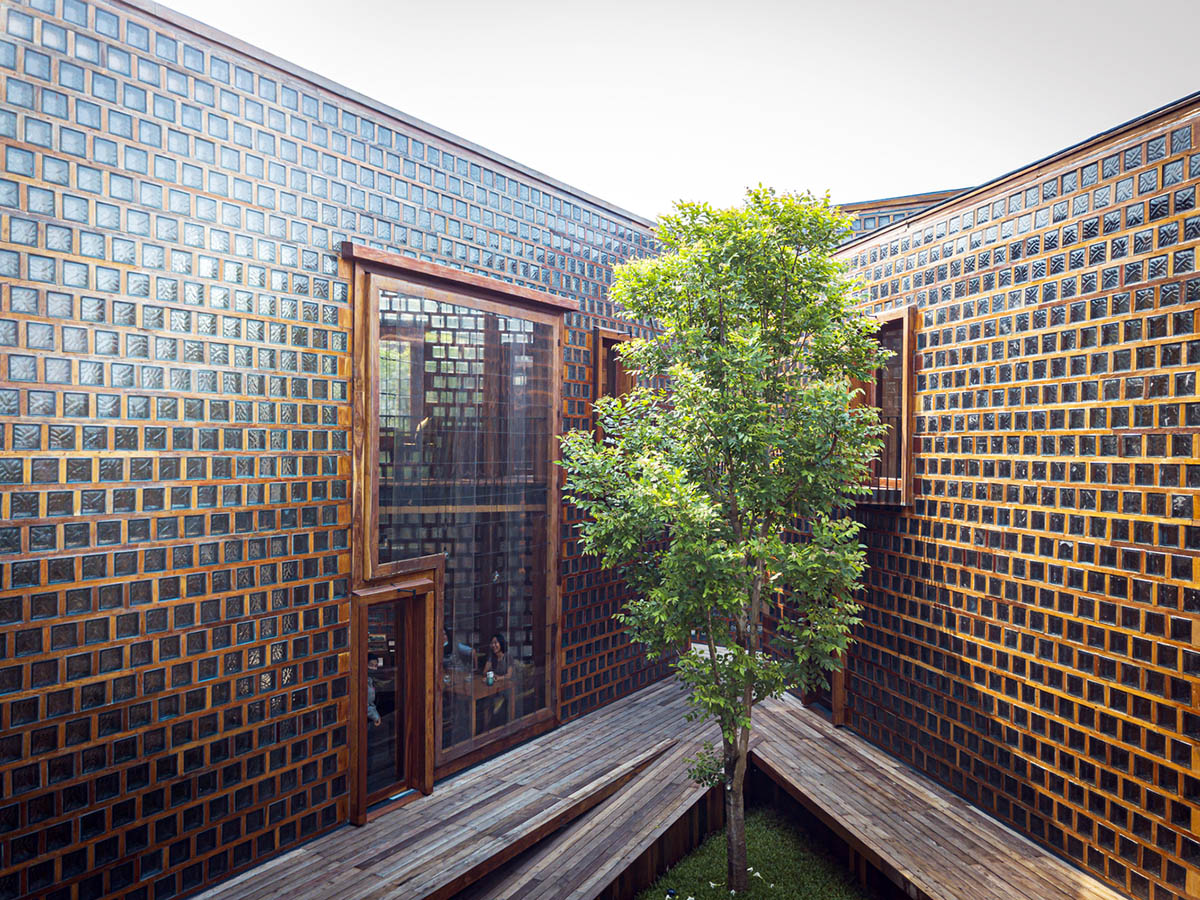 Five glass blocks with framed wood form this woman restaurant designed by Bangkok Project Studio