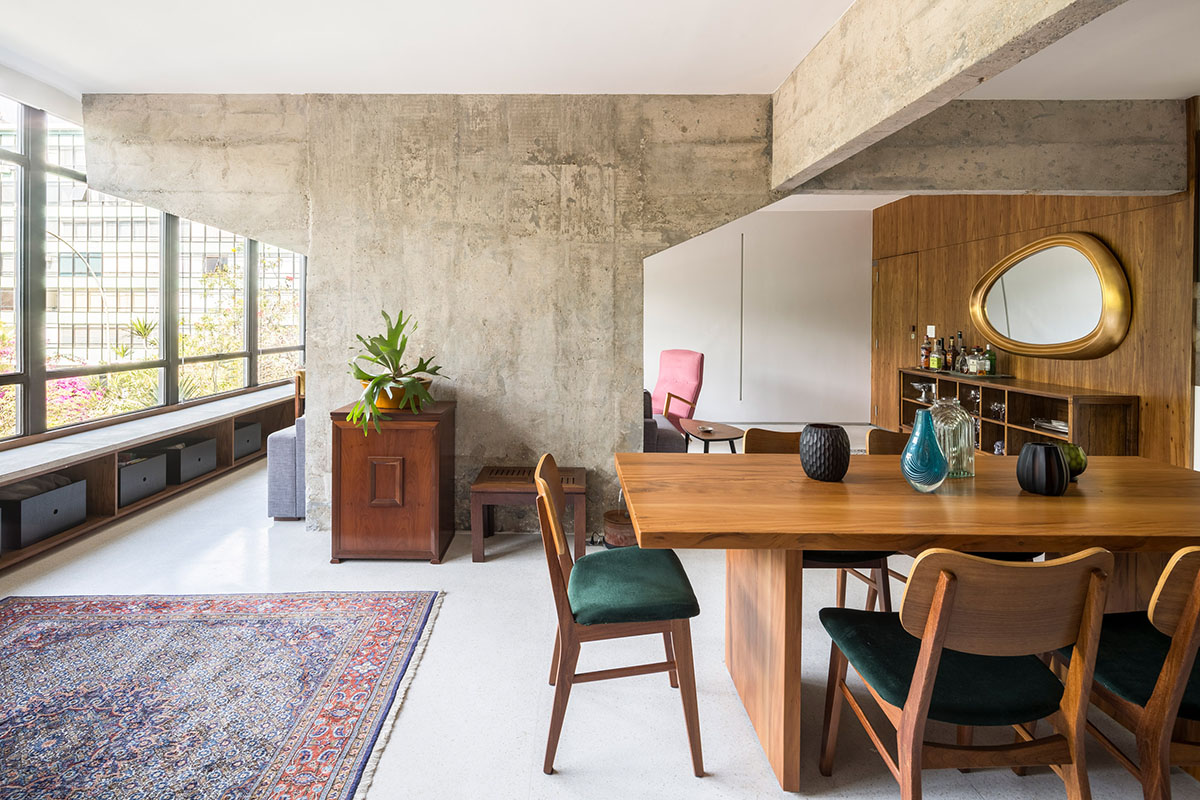 A historic Brazilian apartment has been redesigned with wooden bookcase as main divider