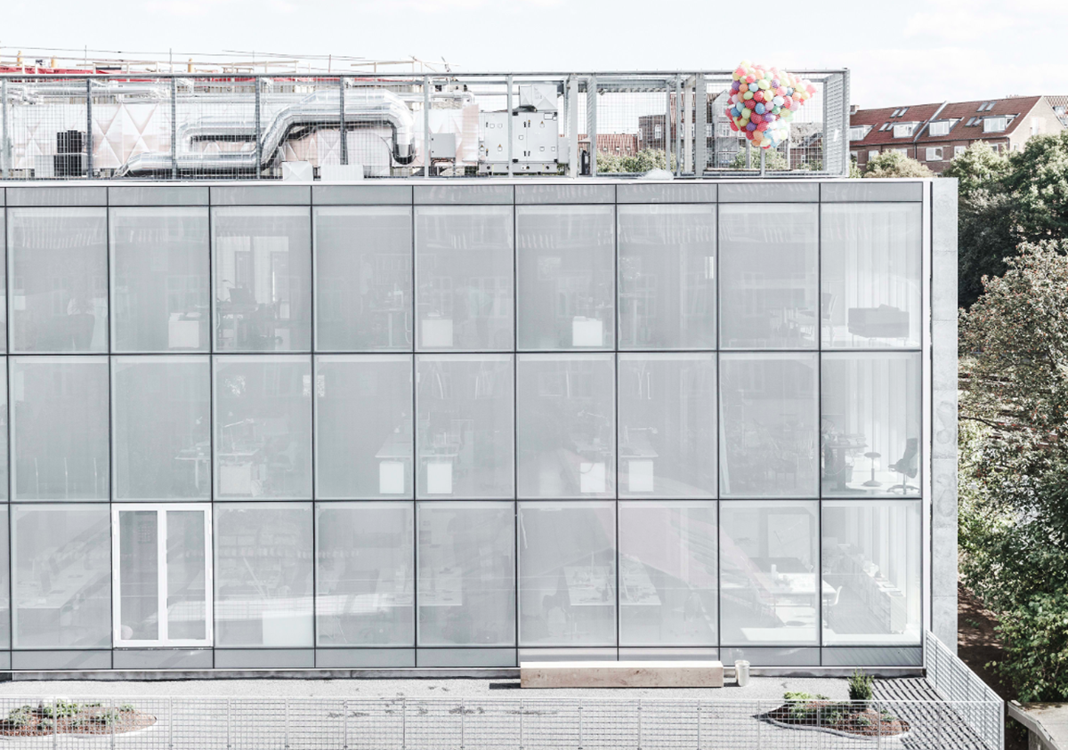 A collage of elements reflecting surroundings assembled on the facade of Office Building by SLETH