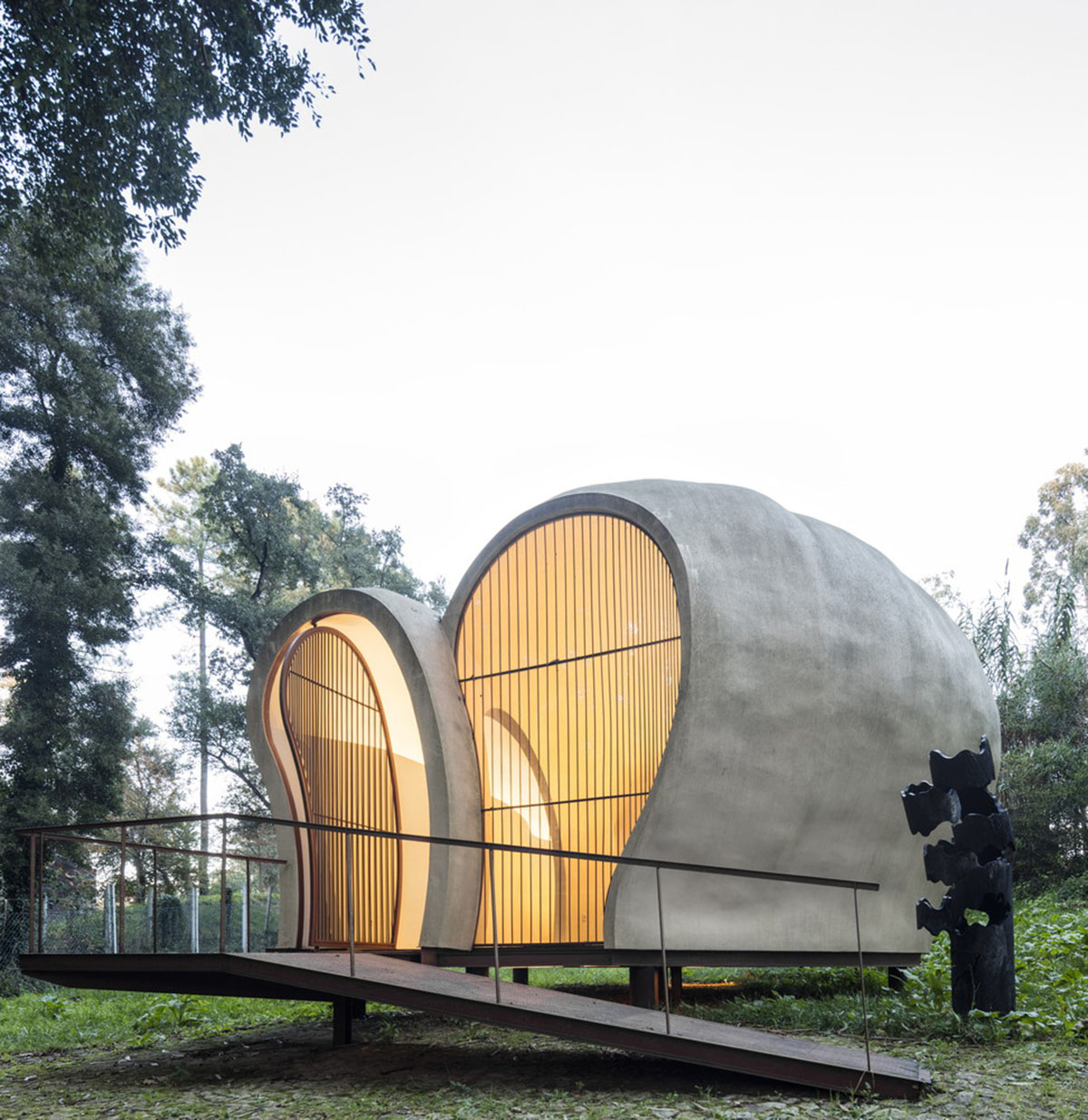 Super small cave-like art gallery by FCC Arquitectura built on lush green in Portugal