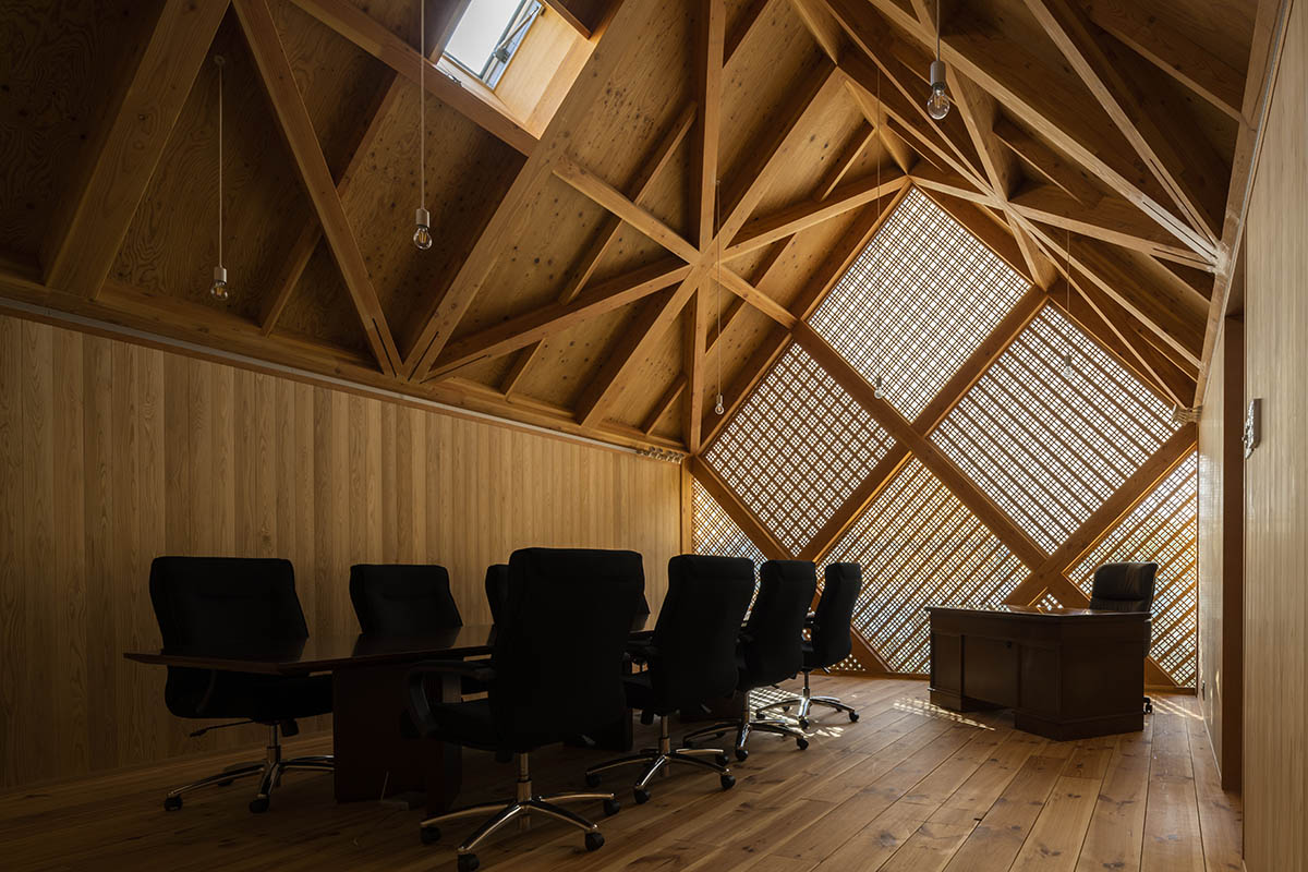 Tezuka Architects' zig zag office building creates lace-like façade with wooden diagonal grids