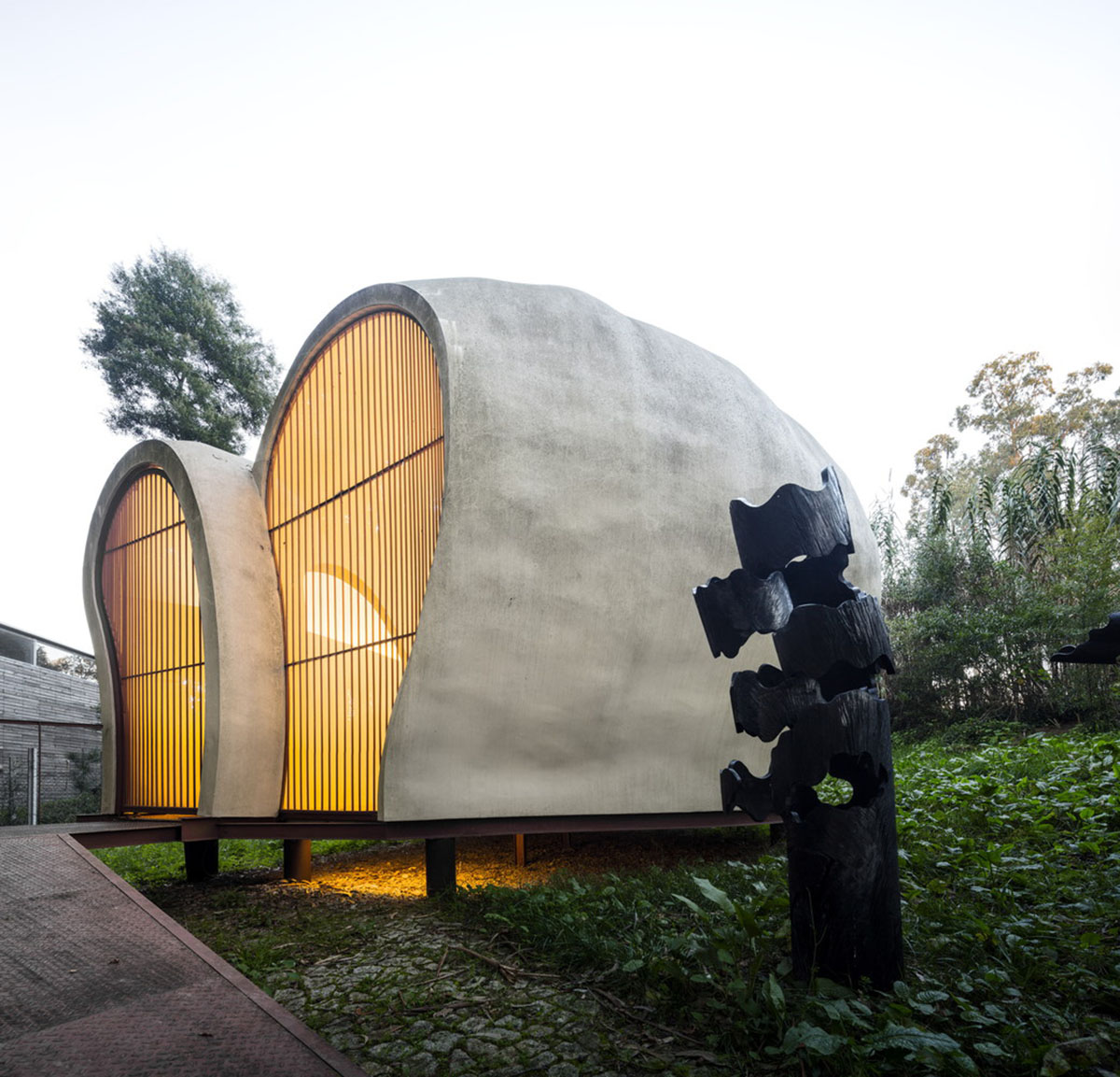 Super small cave-like art gallery by FCC Arquitectura built on lush green in Portugal