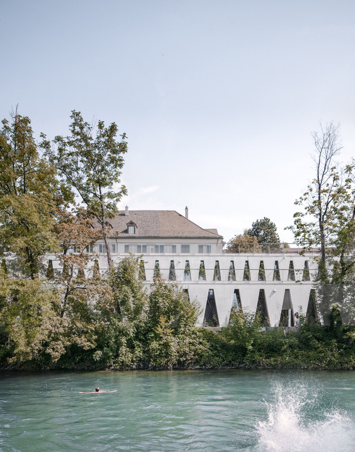 Trapezoidal openings characterize the interiors of cultural center by Estudio Barozzi Veiga in Zürich