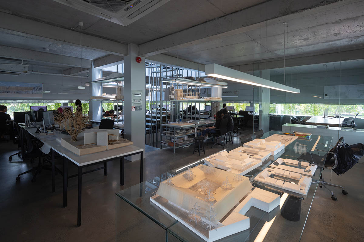 MIA Design Studio created vertical open library inside its office filled with greenery in Vietnam