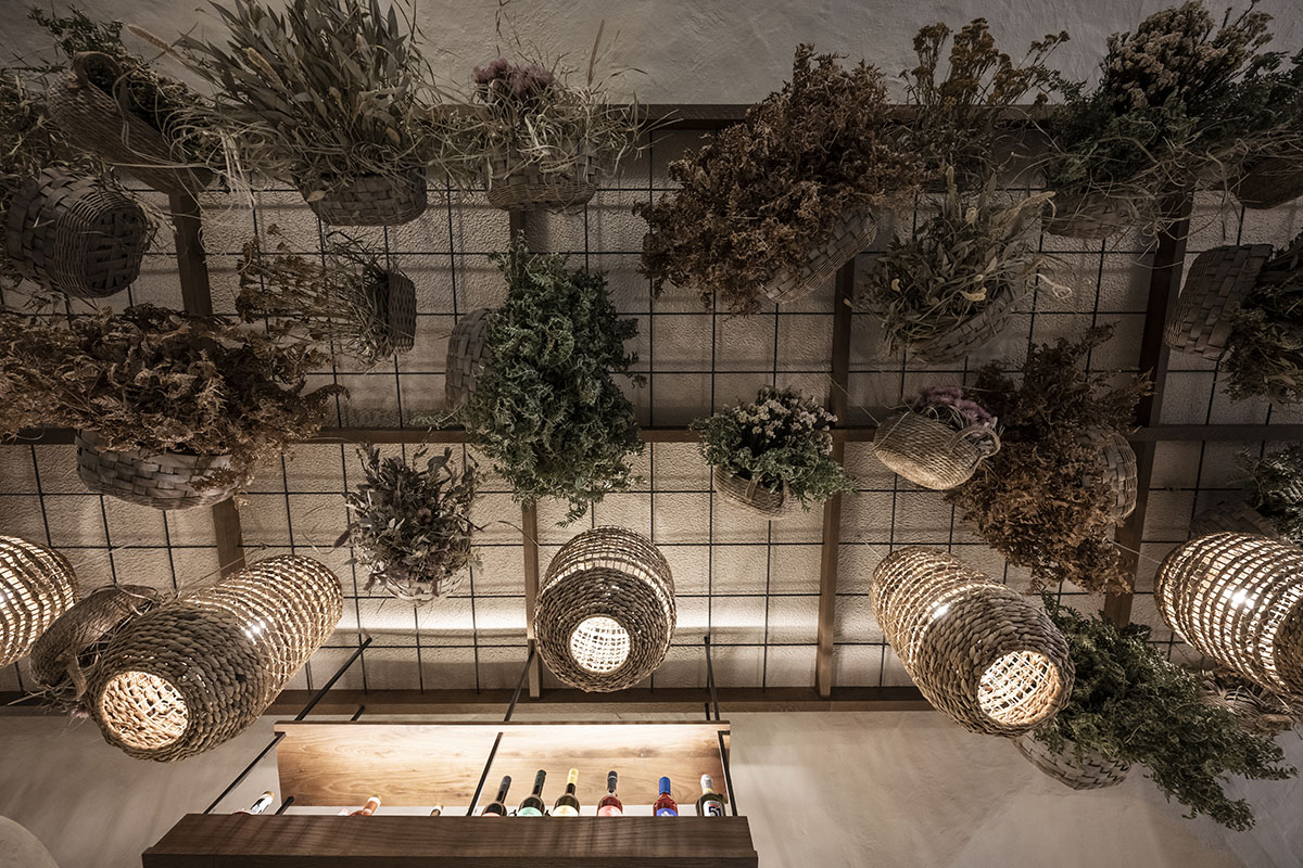 noa* transforms 19th-century workshop house into bohemian-style bistro with deep alcoves in Italy