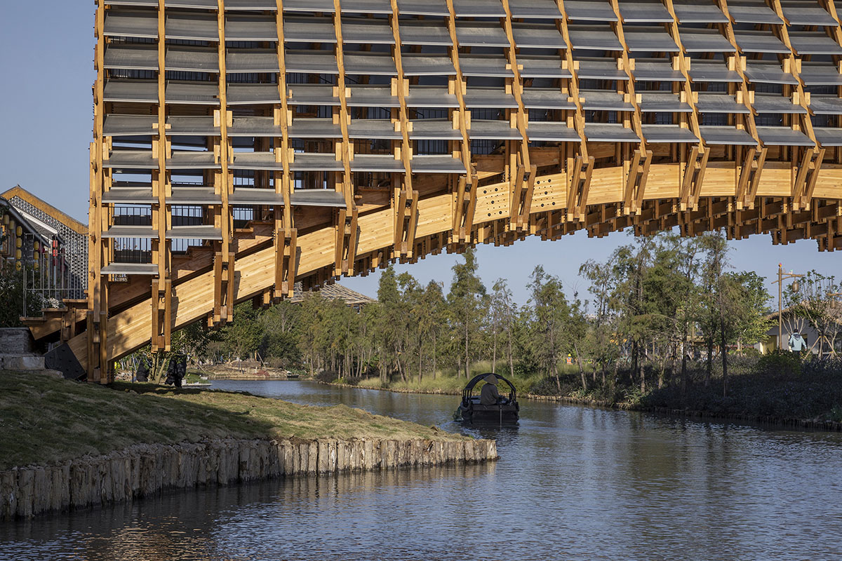 Arched timber bridge by LUO studio allows boats to pass under bridge smoothly in Gulou waterfront