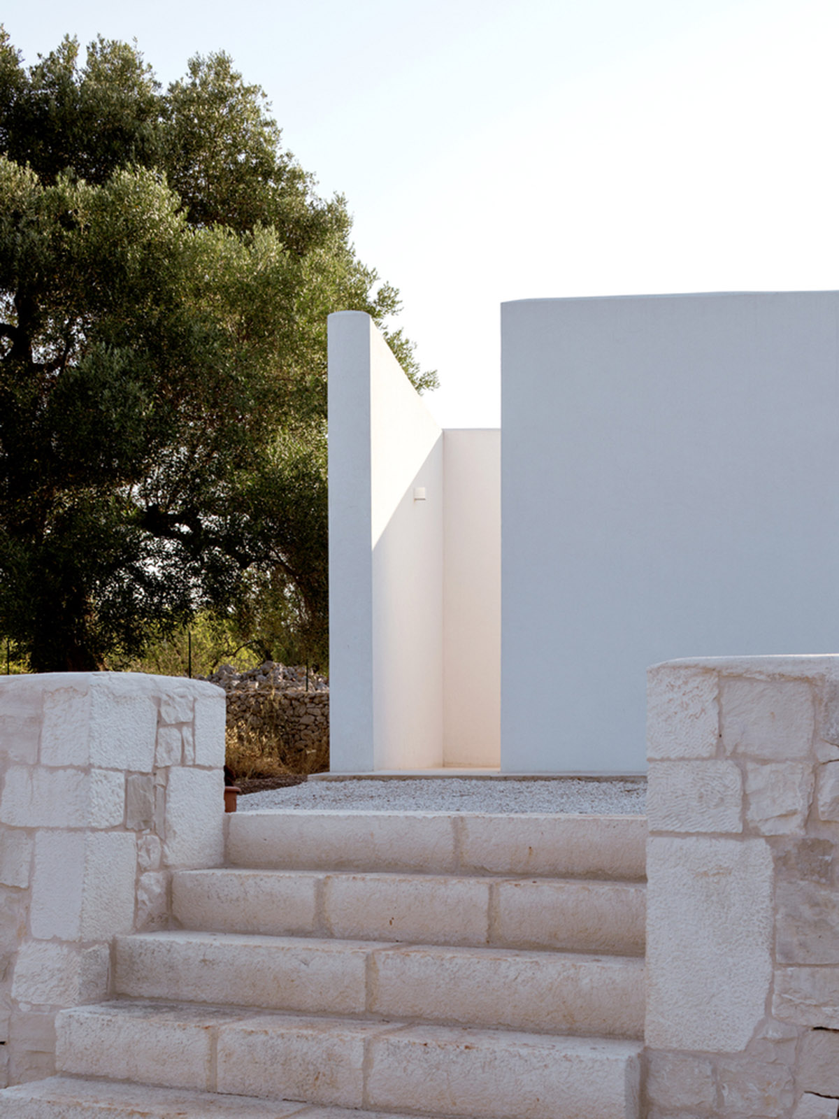 Noname Studio designs townhouse with all-white abstract sculpted volumes among olive trees