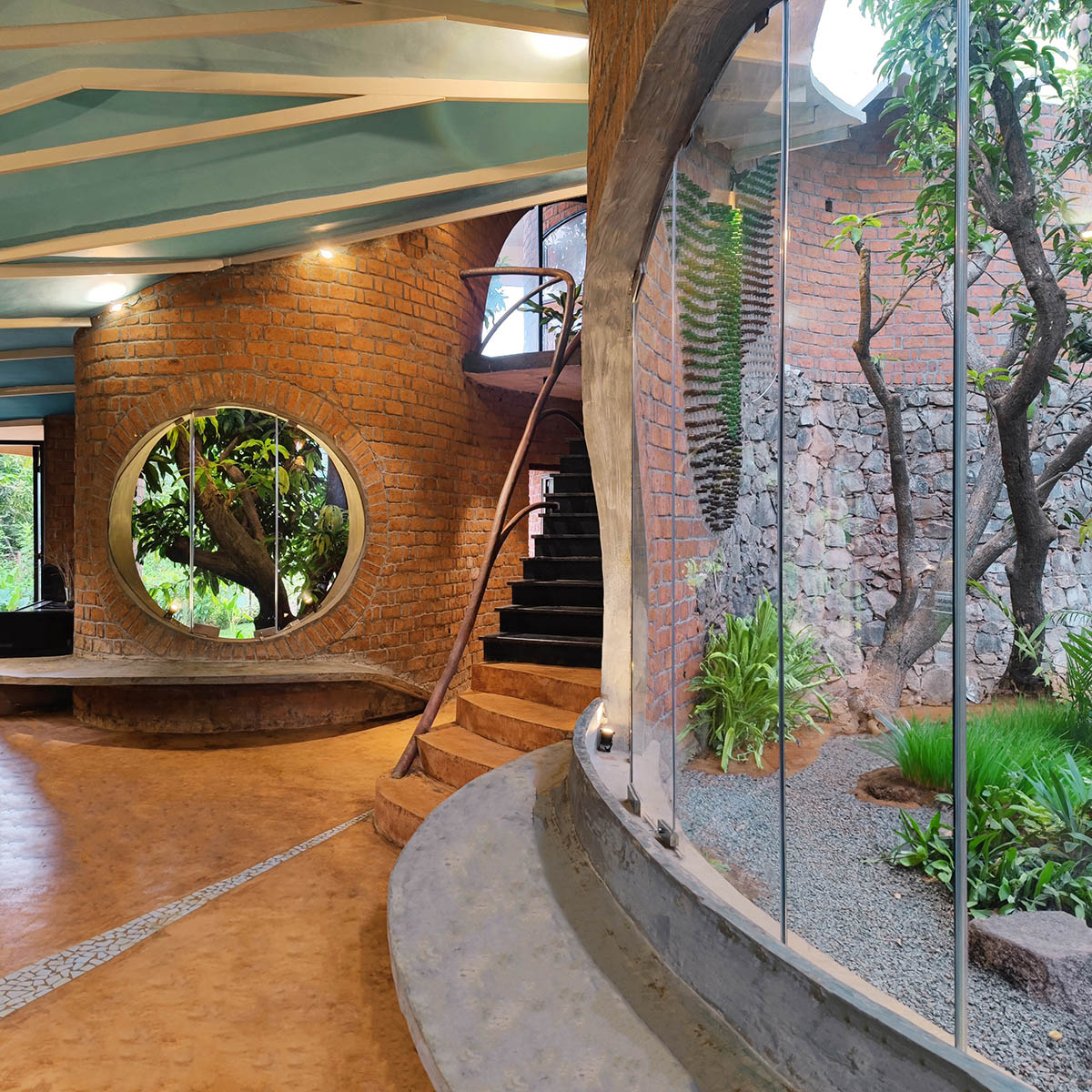 Organically-arranged brick walls form biophilic Asmalay house by Blurring Boundaries in India 