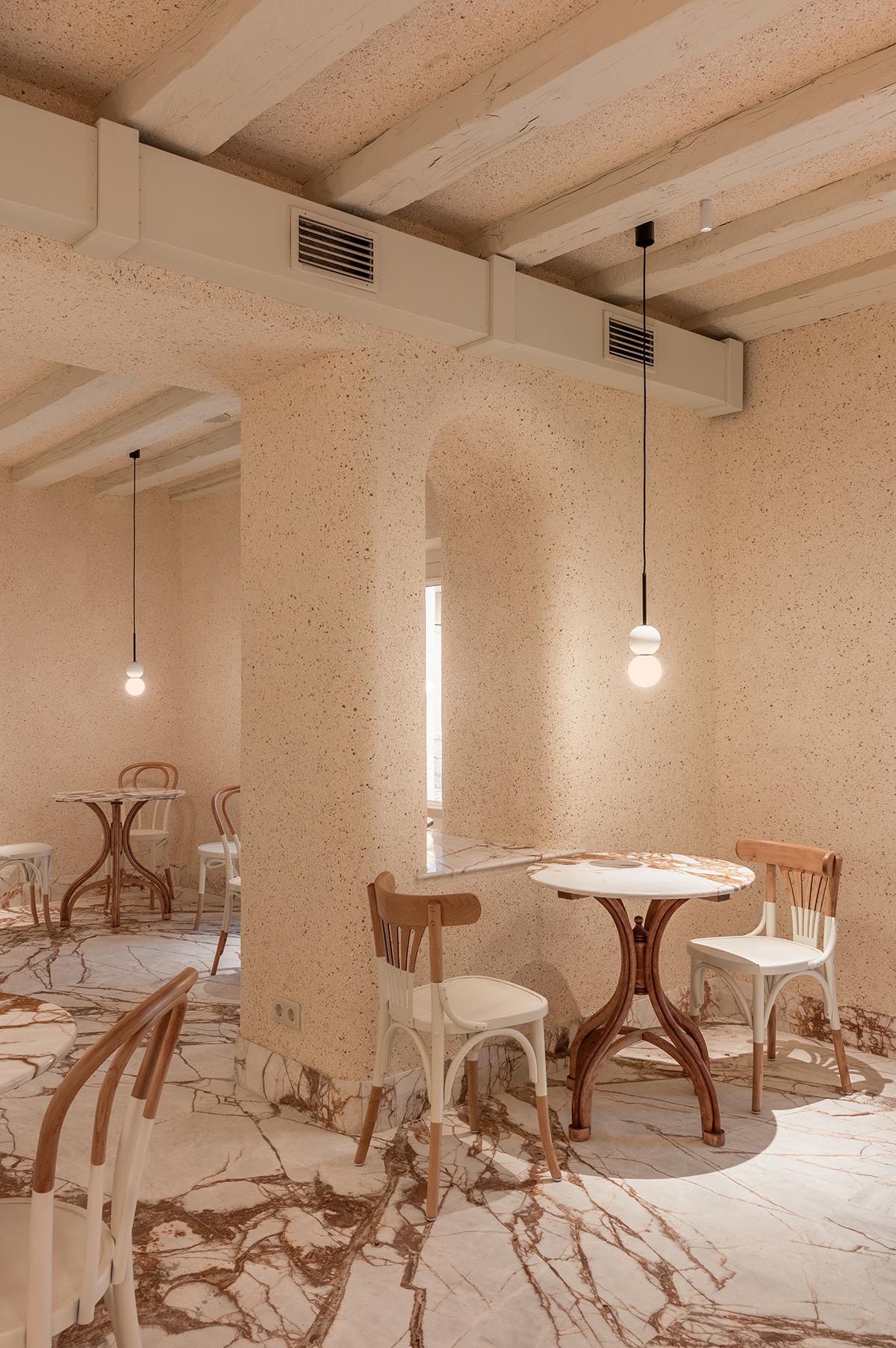 YOD Group clads the walls of a pastry shop in eggshell plaster in Lviv, Ukraine