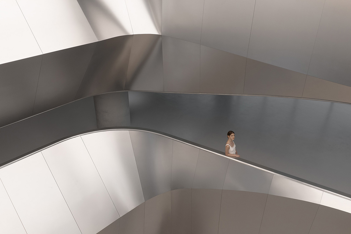 E Studio takes visitors into space travel with a flow of sculpted stainless steel for a showroom