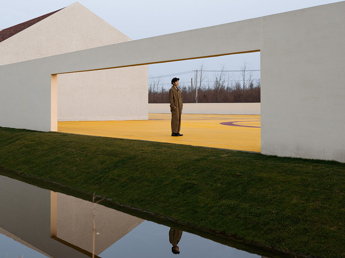 Wutopia Lab converts abandoned barnyard into a golden yellow field resembling a frozen harvest time