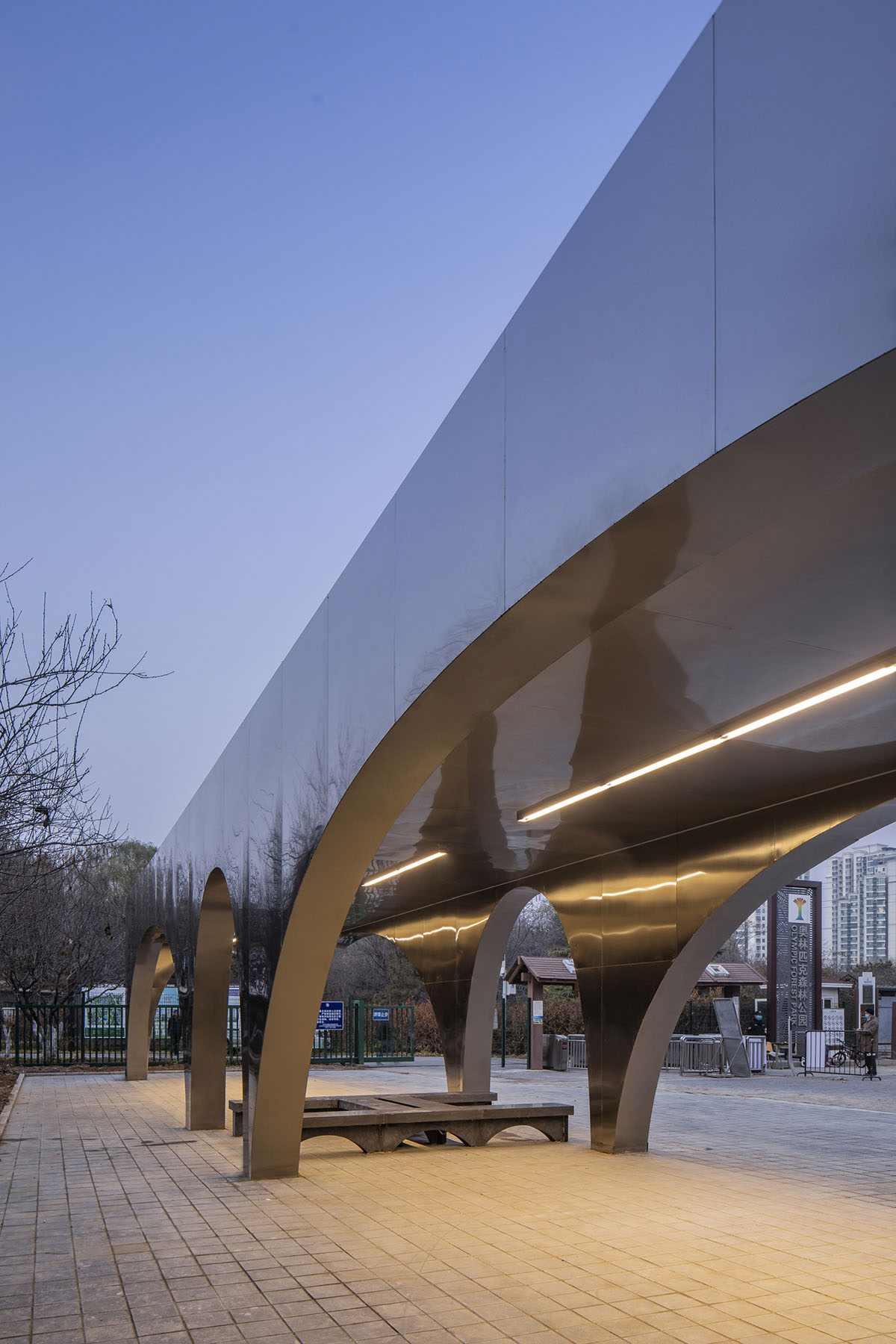 TEMP designs runner's station with stainless steel arcades in Beijing Olympic Forest Park