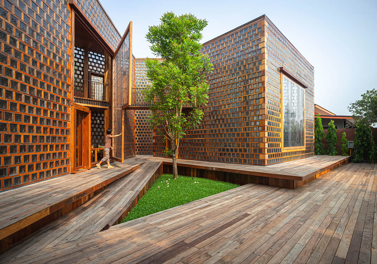 Five glass blocks with framed wood form this woman restaurant designed by Bangkok Project Studio