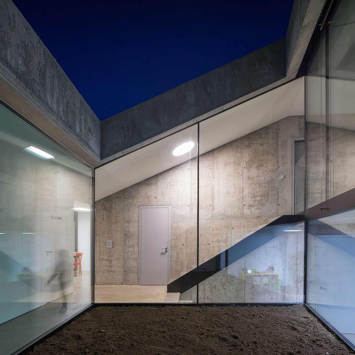 Anako Architecture completes slopped concrete residence in Switzerland