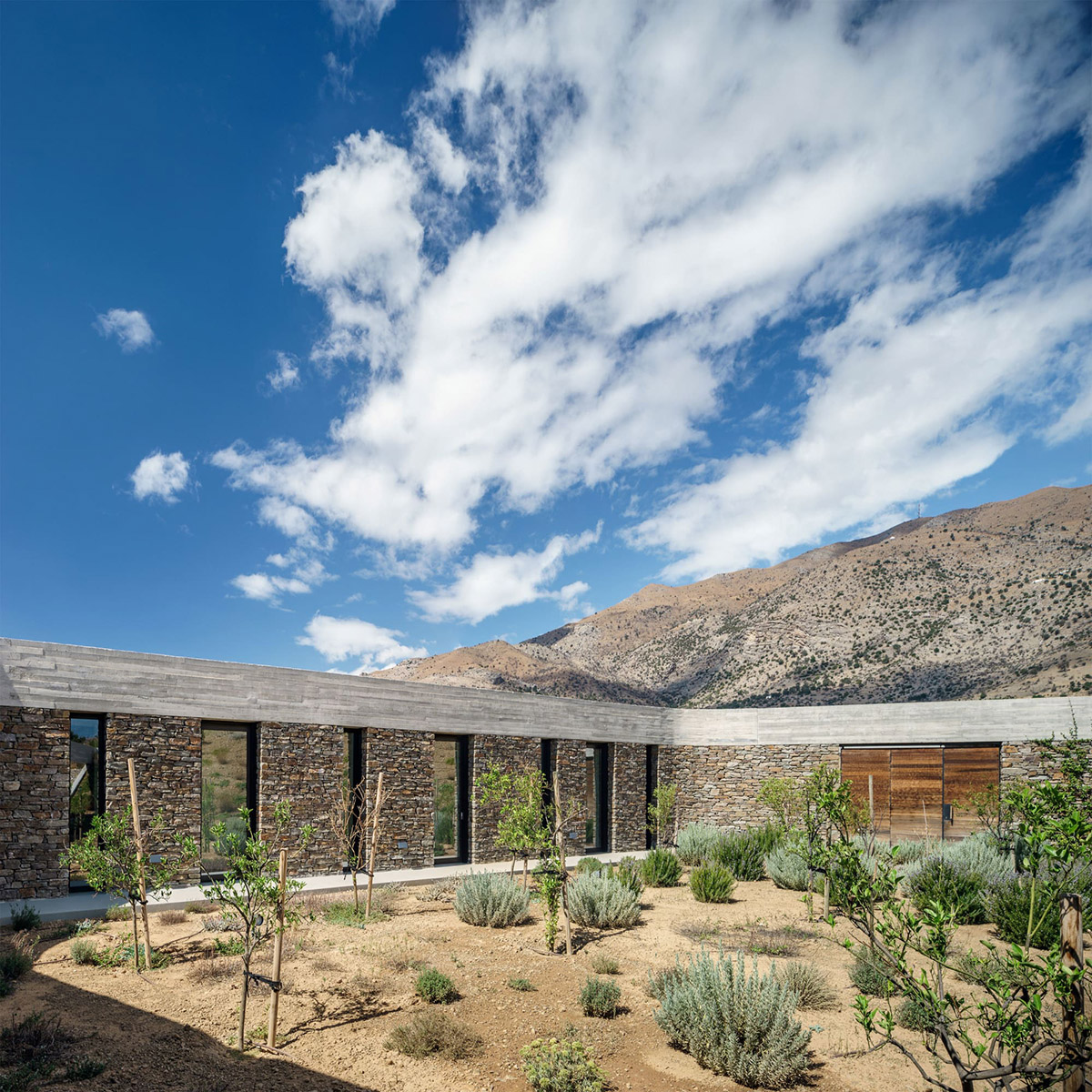 DecaACHITECTURE Completes Ring House On Top Of Deserted Landscape Of Crete