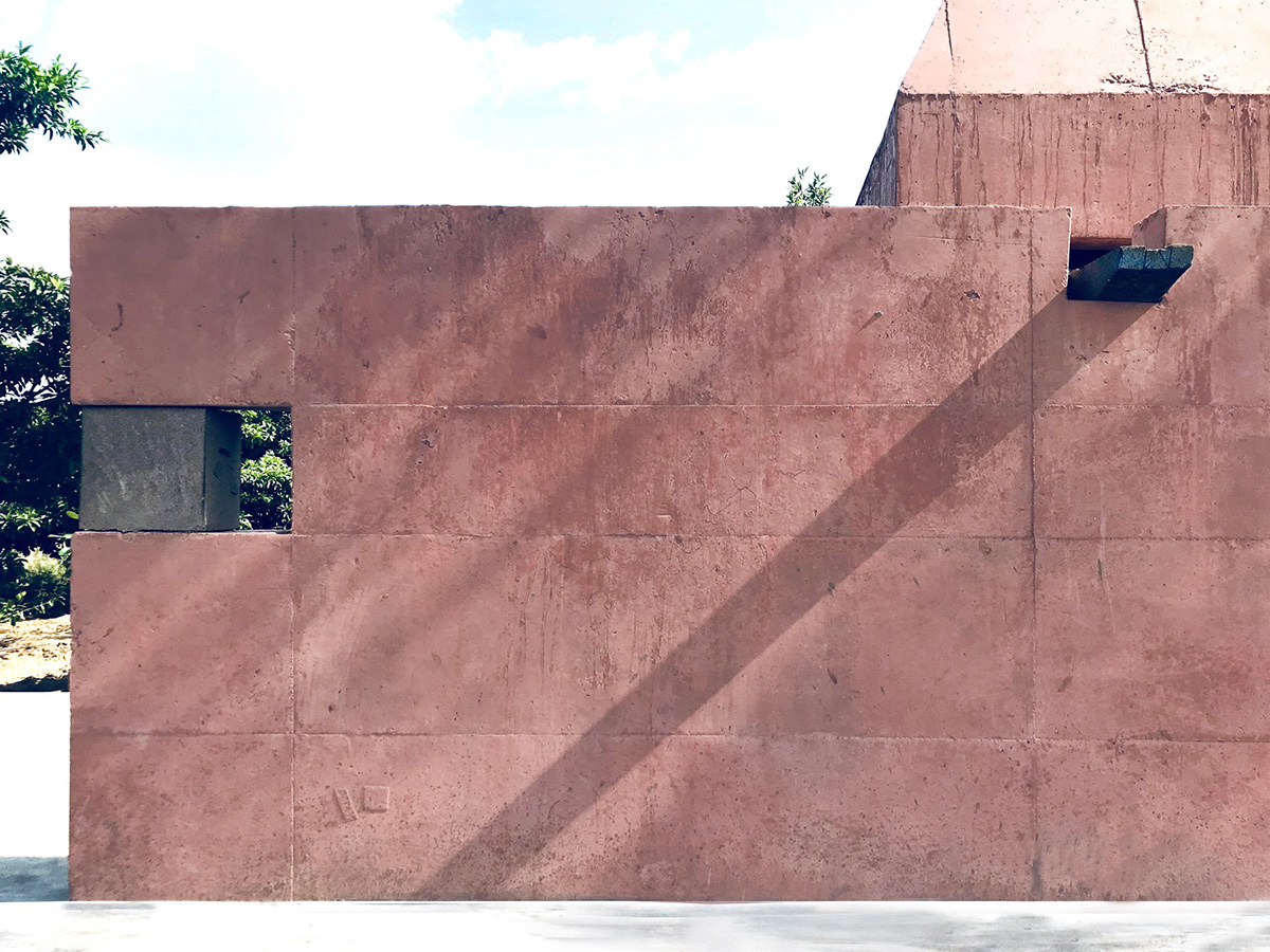 Karan Darda Architects Built A Sculptural Temple With Reddish-Colored Concrete Walls In Pune