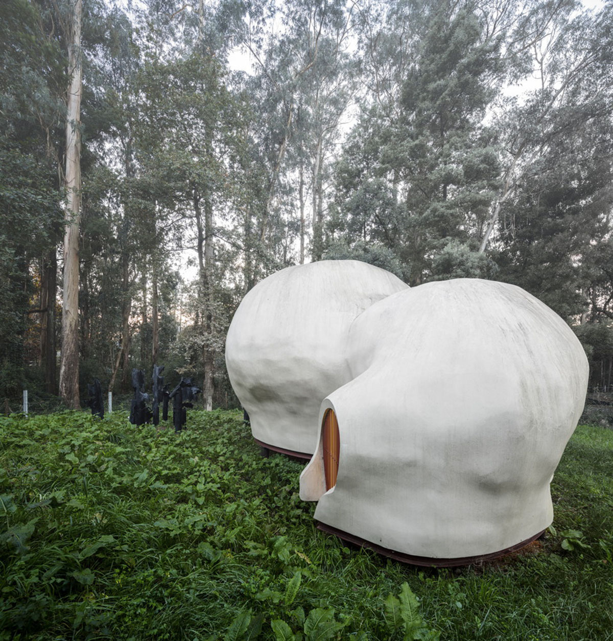 Super small cave-like art gallery by FCC Arquitectura built on lush green in Portugal