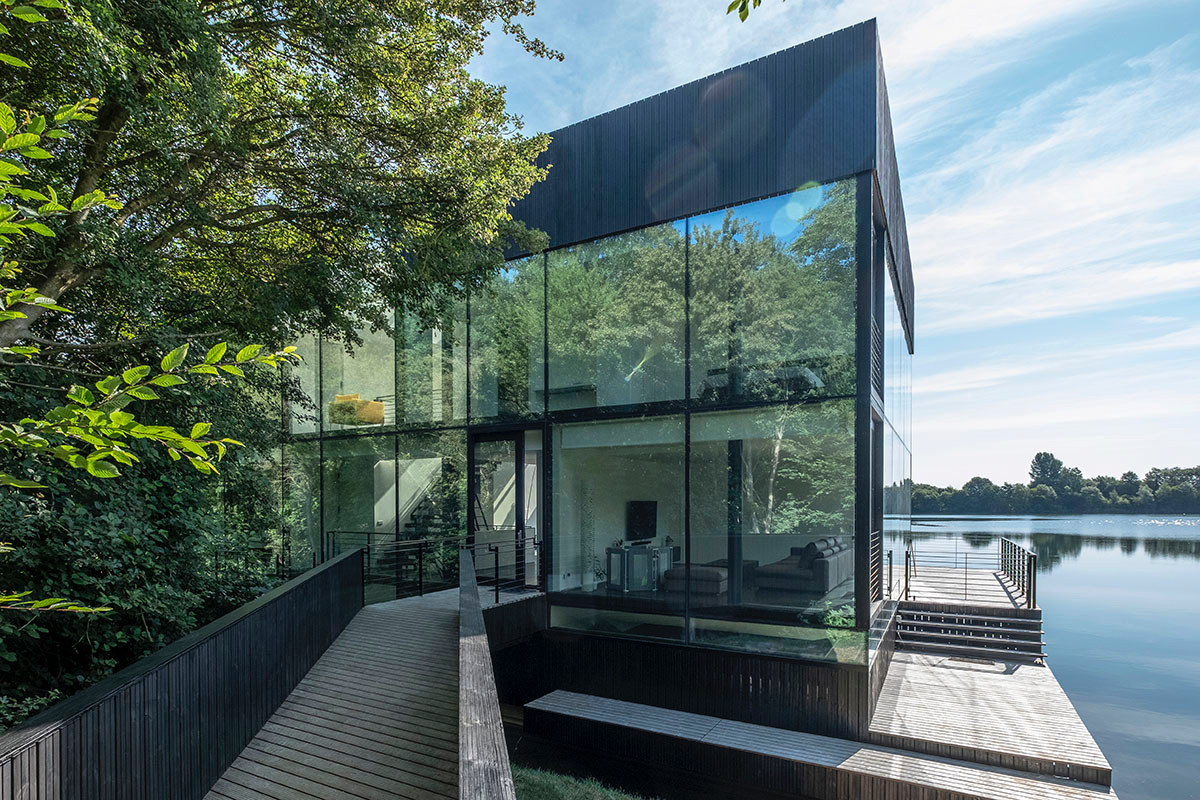 Mecanoo Completes Glass Villa With Dark Stripes On A Lake In Lechlade