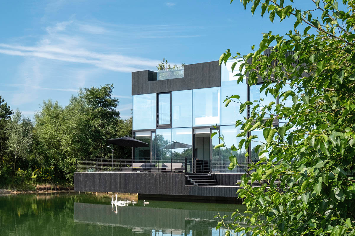 Mecanoo Completes Glass Villa With Dark Stripes On A Lake In Lechlade