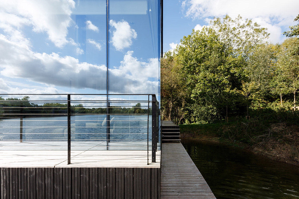 Mecanoo Completes Glass Villa With Dark Stripes On A Lake In Lechlade