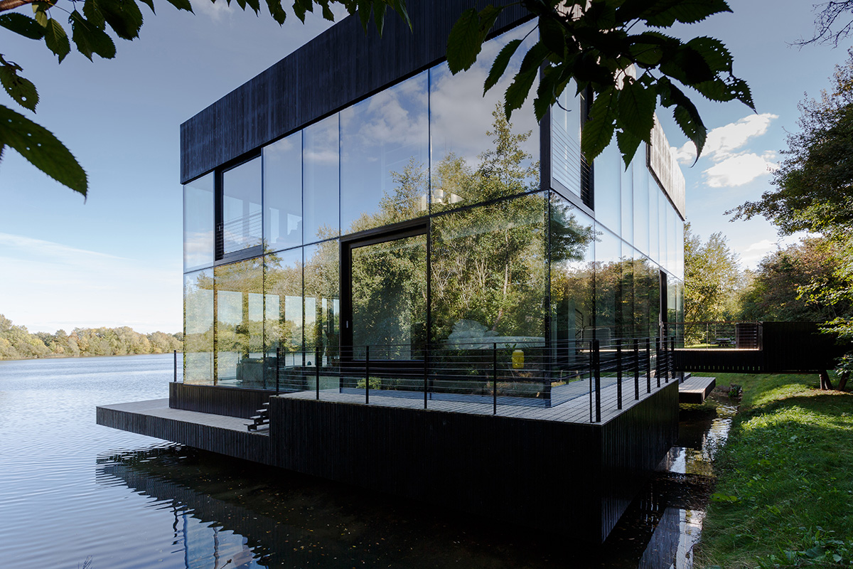 Mecanoo Completes Glass Villa With Dark Stripes On A Lake In Lechlade