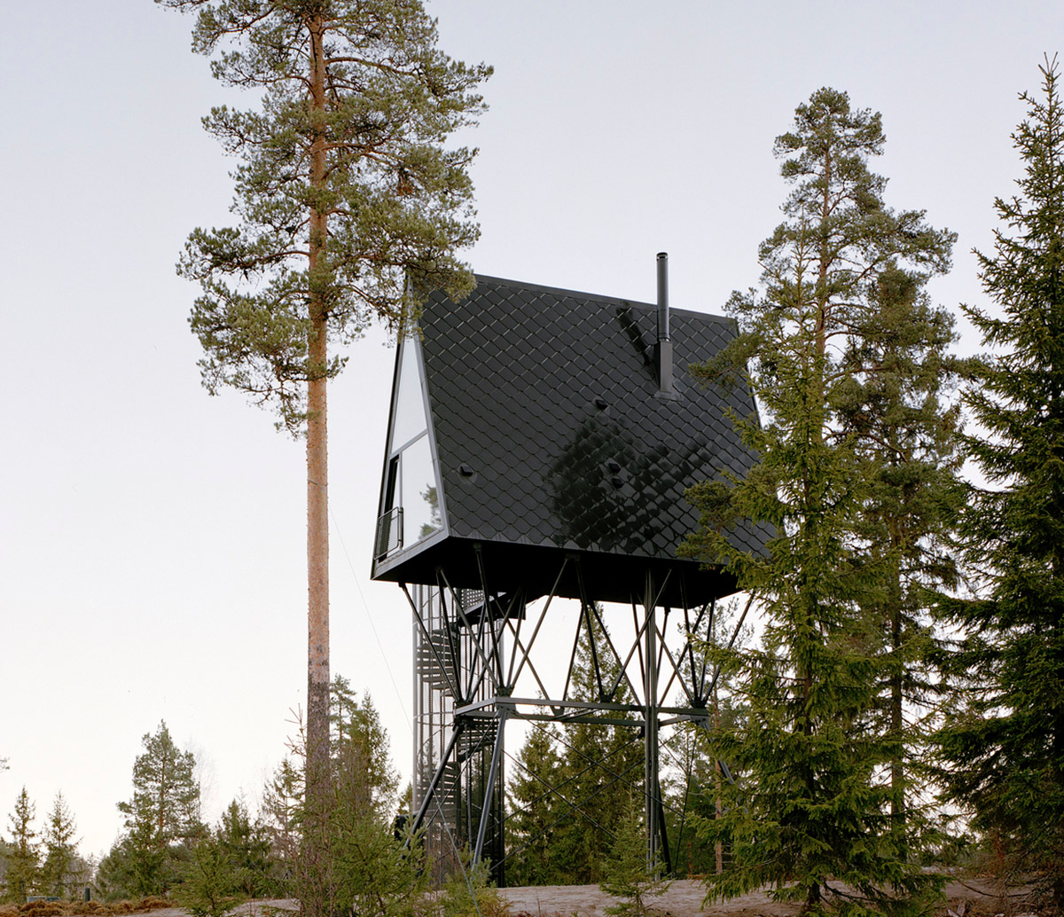 Espen Surnevik uses simple geometry for cabins raised on slim columns in forest area of Norway