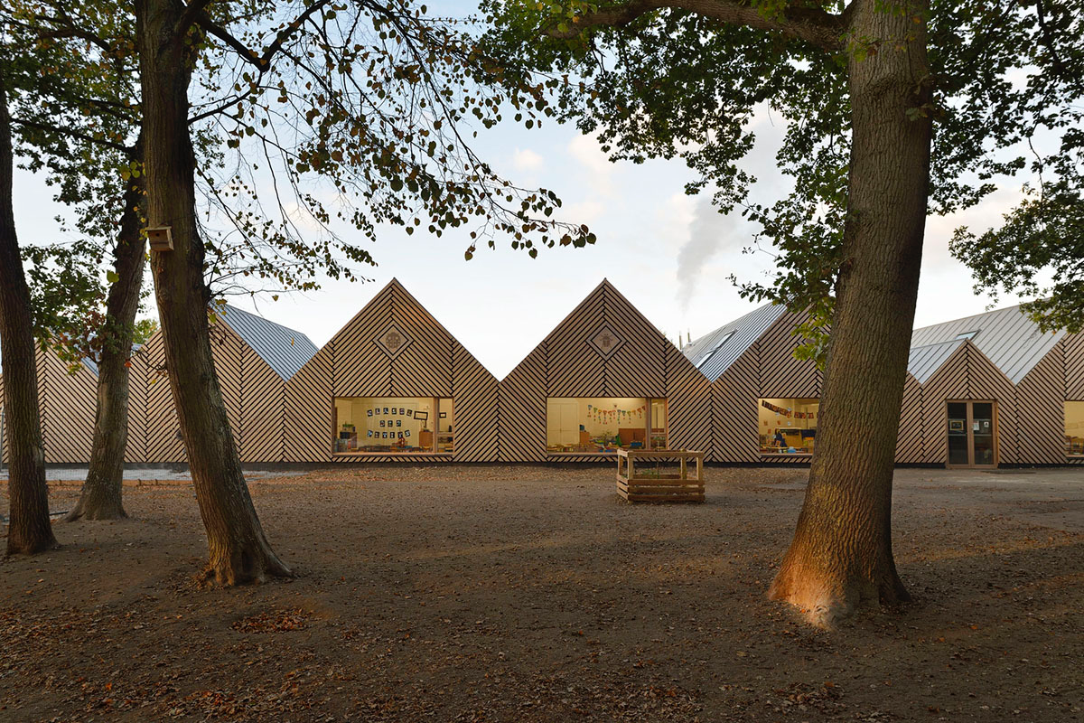 This human-scale school in French town wrapped by different geometry of wood claddings
