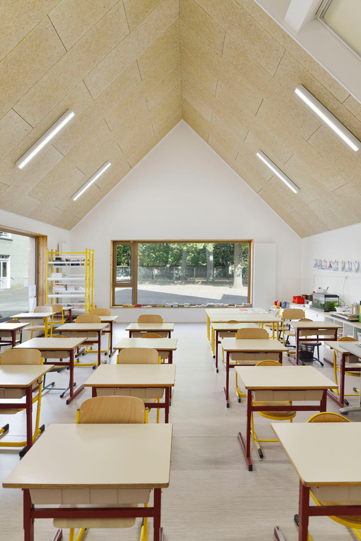 This human-scale school in French town wrapped by different geometry of wood claddings