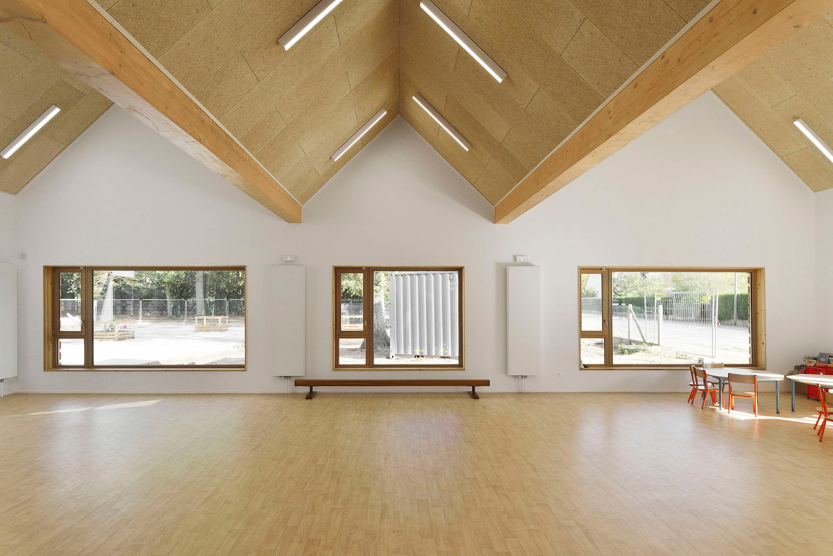 This human-scale school in French town wrapped by different geometry of wood claddings