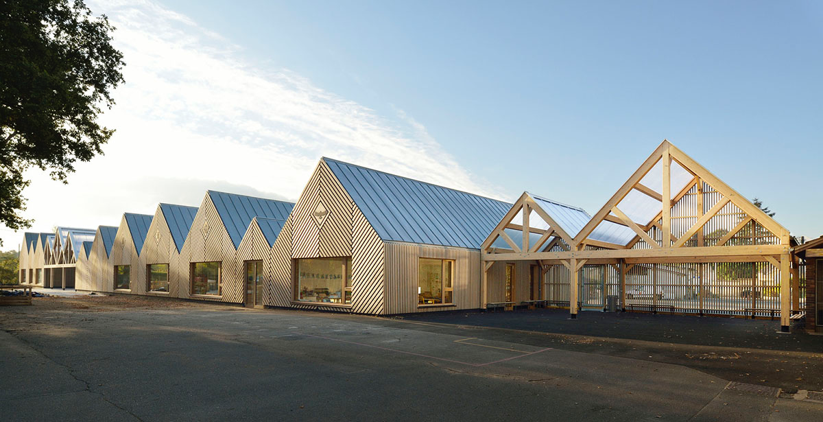 This human-scale school in French town wrapped by different geometry of wood claddings
