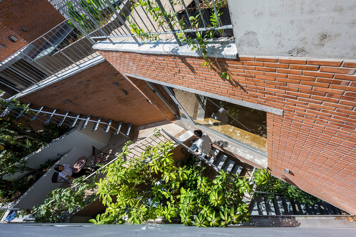 VTN Architects' new cascading family house creates large green gardens in a narrow site of Vietnam