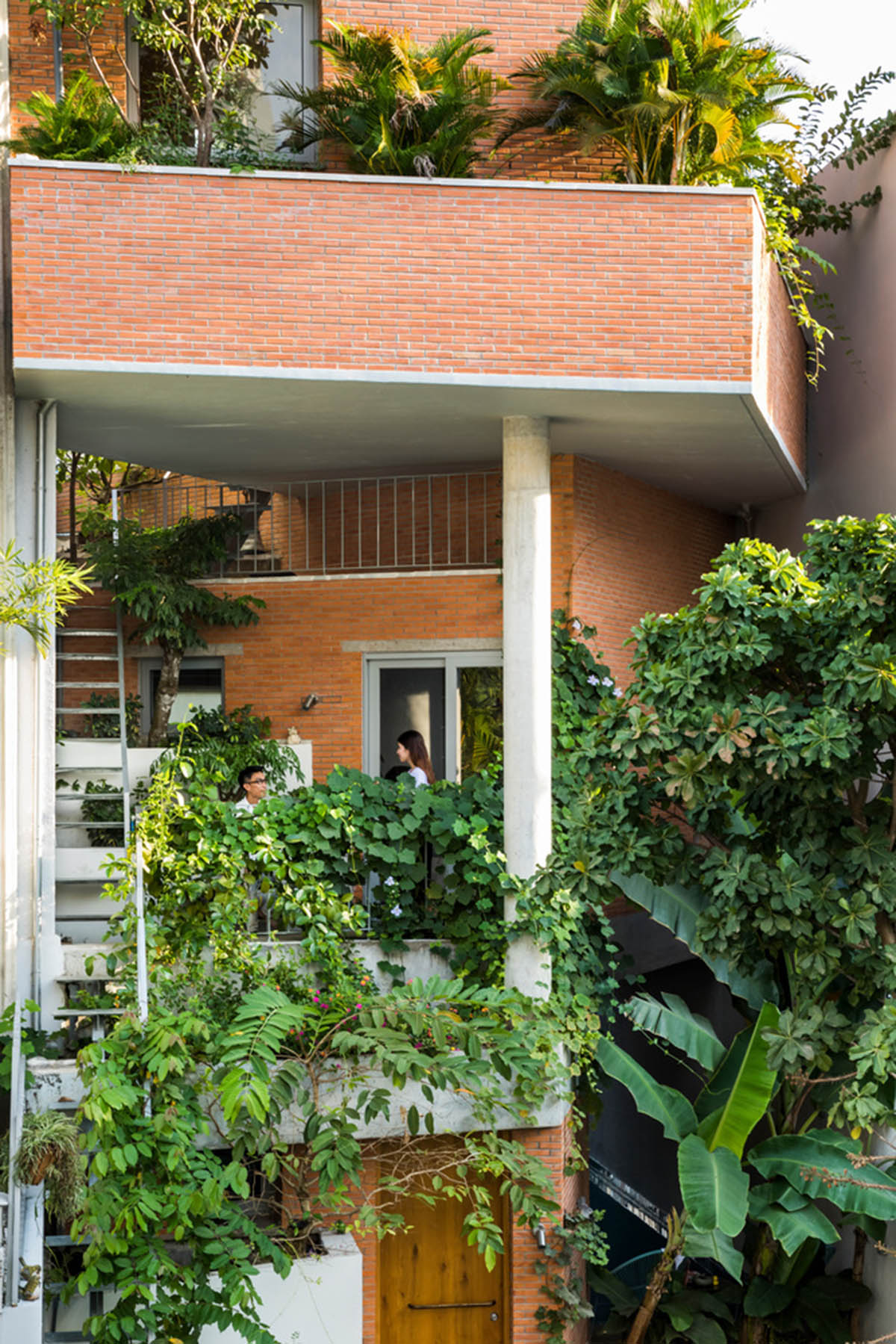VTN Architects' new cascading family house creates large green gardens in a narrow site of Vietnam