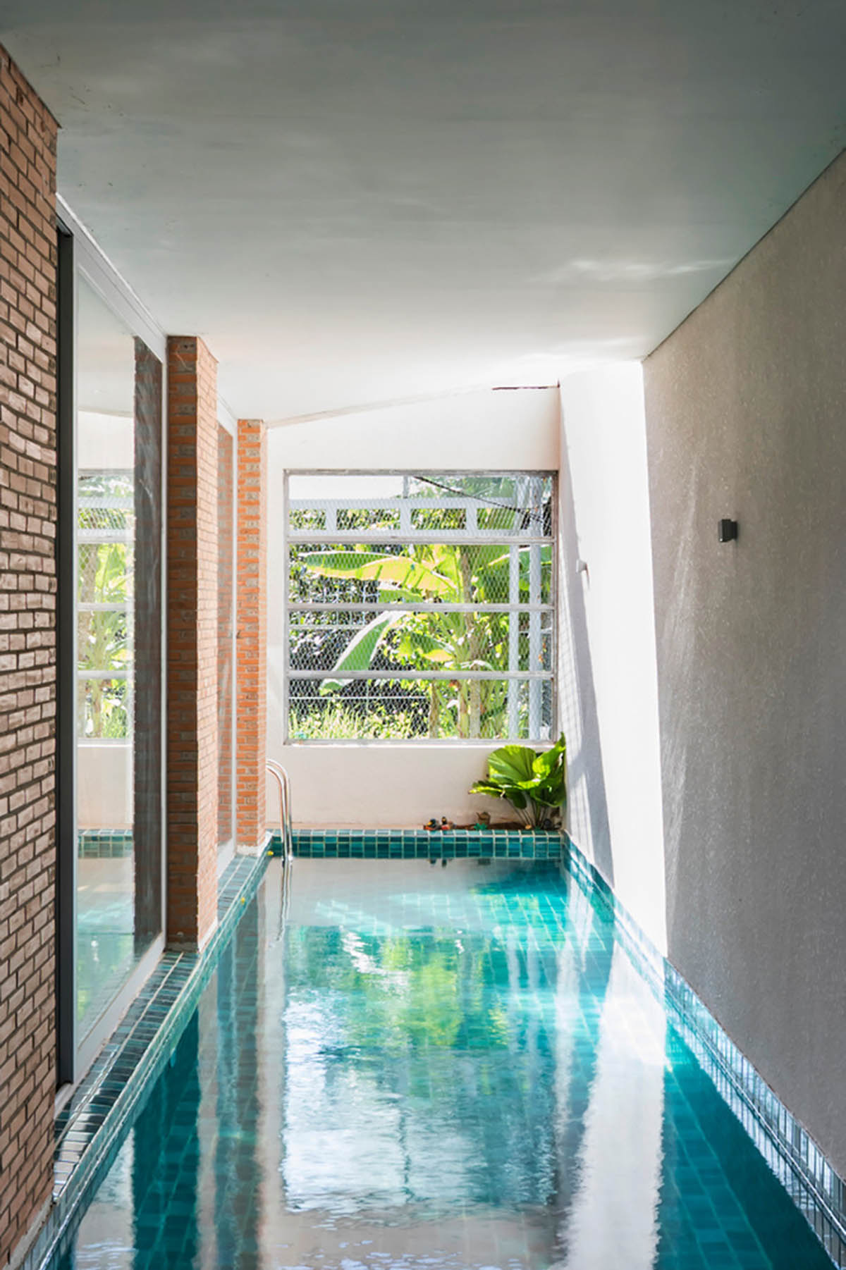 VTN Architects' new cascading family house creates large green gardens in a narrow site of Vietnam