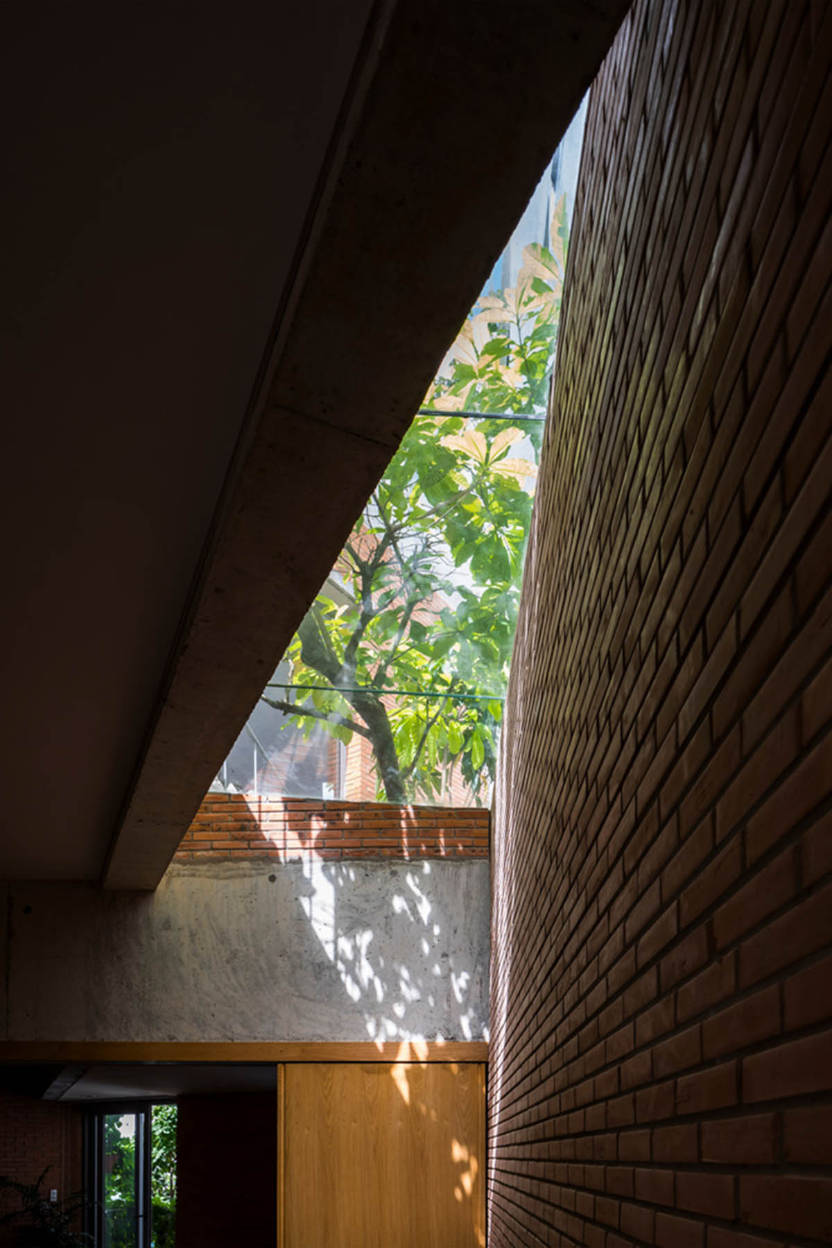 VTN Architects' new cascading family house creates large green gardens in a narrow site of Vietnam