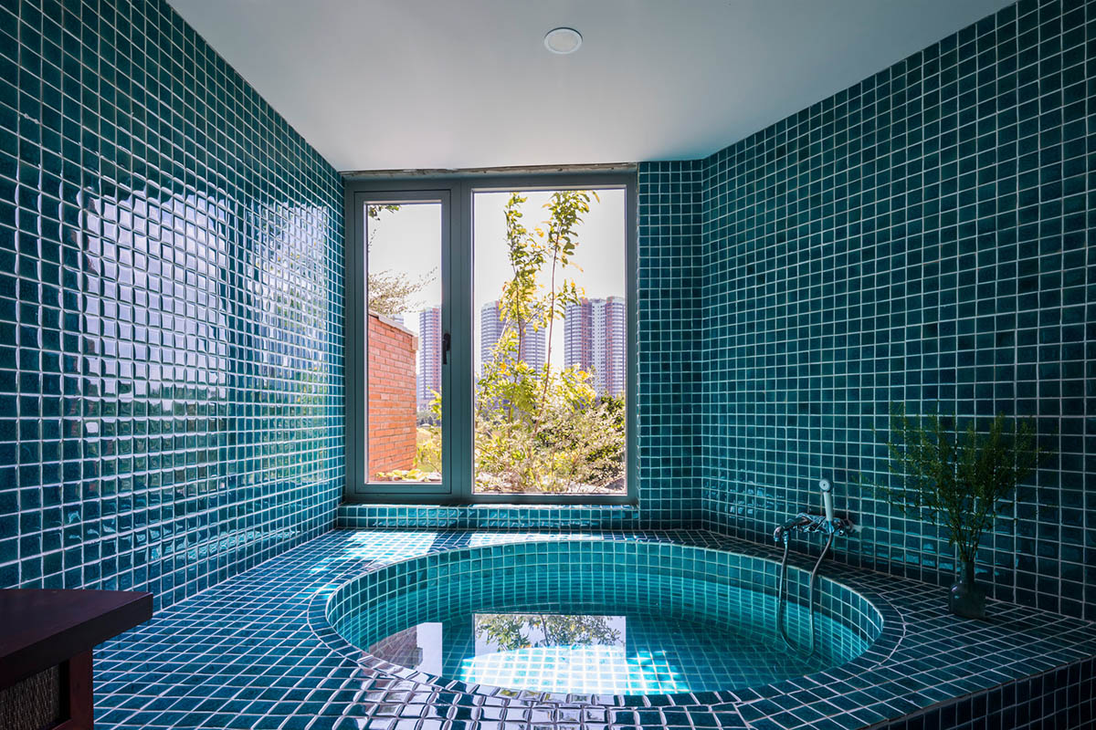 VTN Architects' new cascading family house creates large green gardens in a narrow site of Vietnam