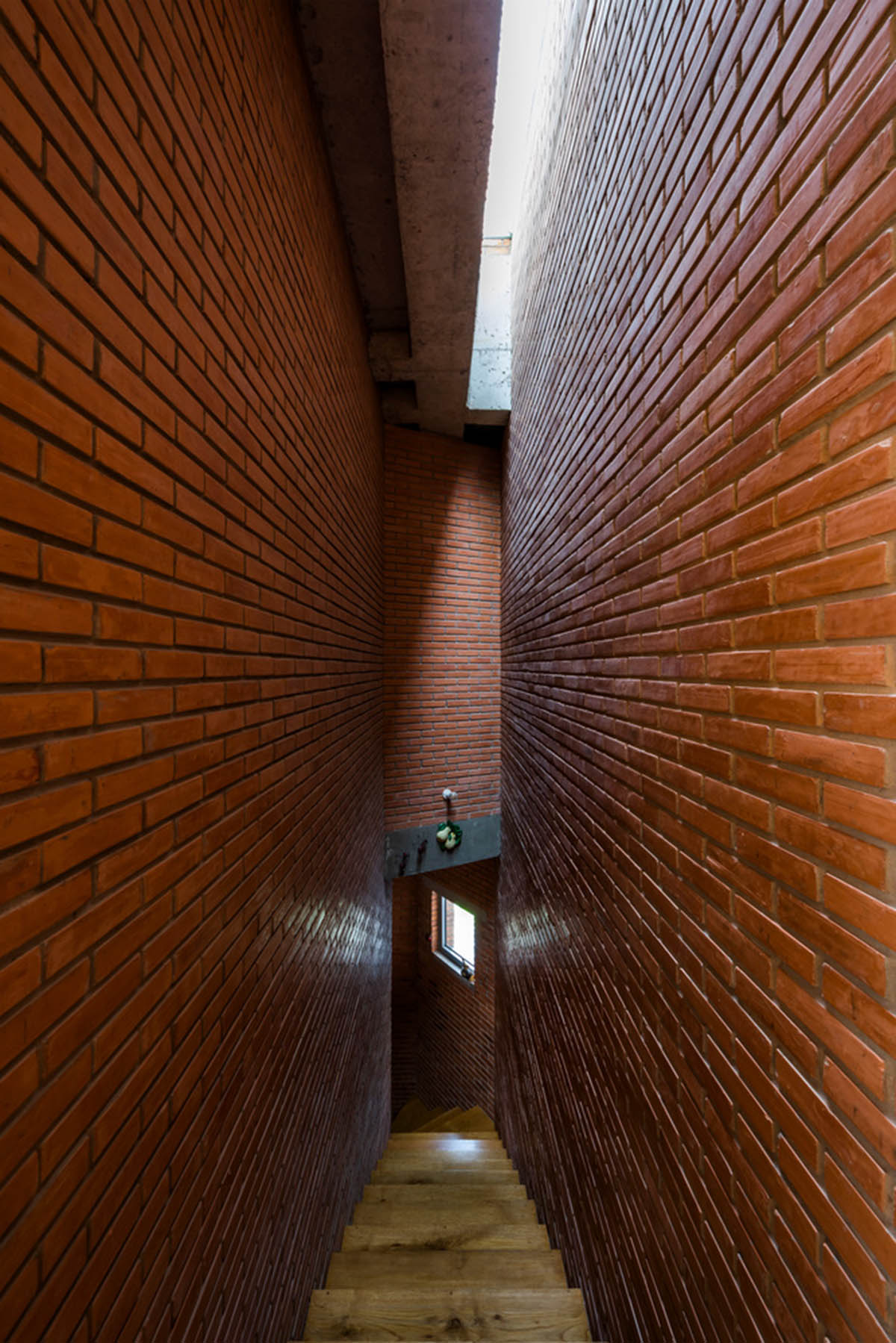 VTN Architects' new cascading family house creates large green gardens in a narrow site of Vietnam