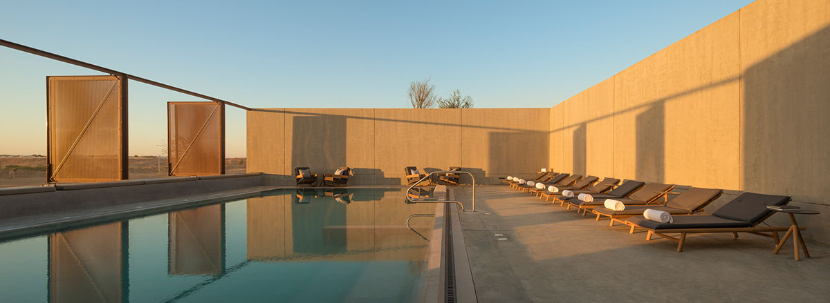 Anarchitect nestles this earth color hotel and spa building into the prehistoric of UAE