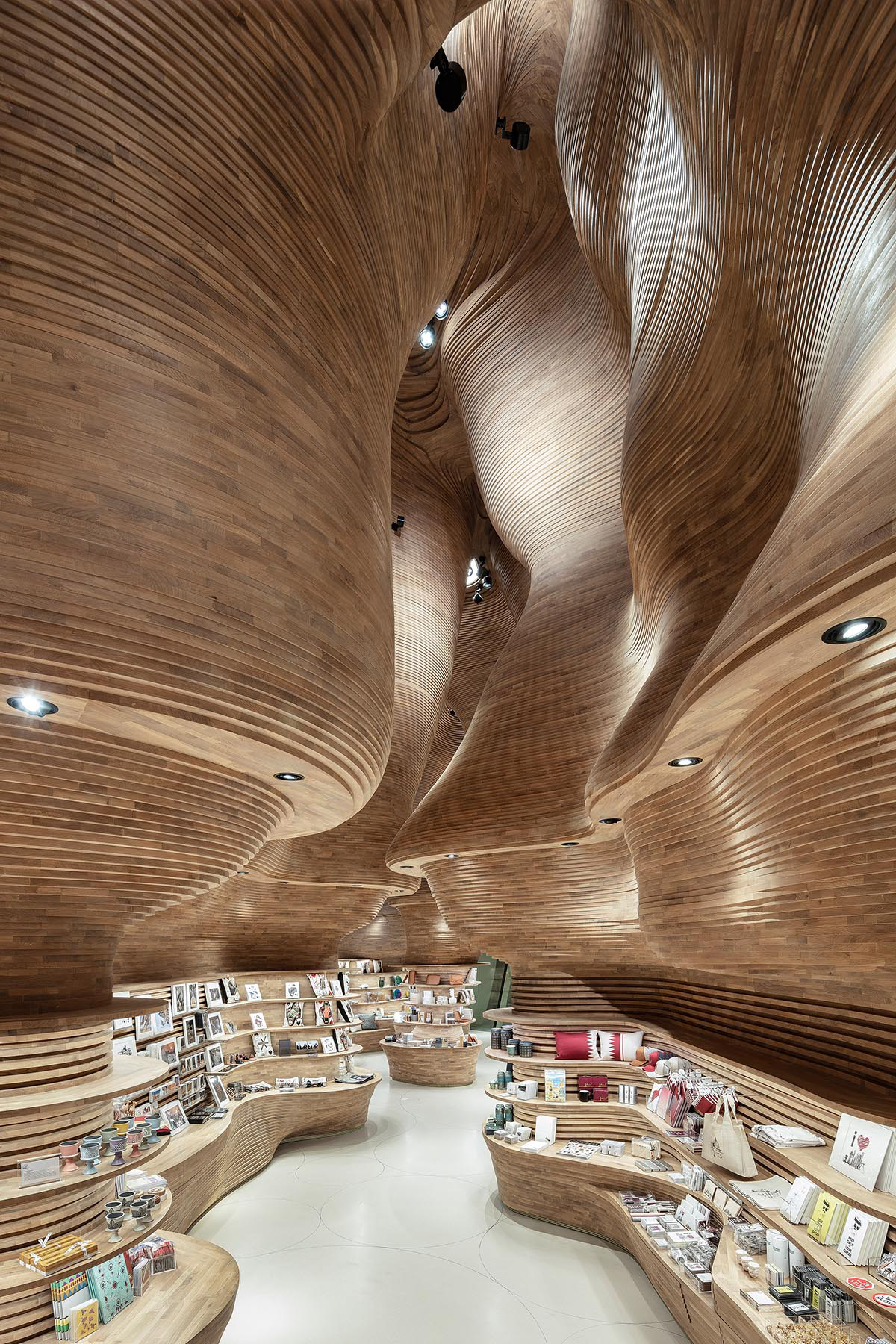 Koichi Takada Architects creates cave-like interior for museum shops inside National Museum of Qatar