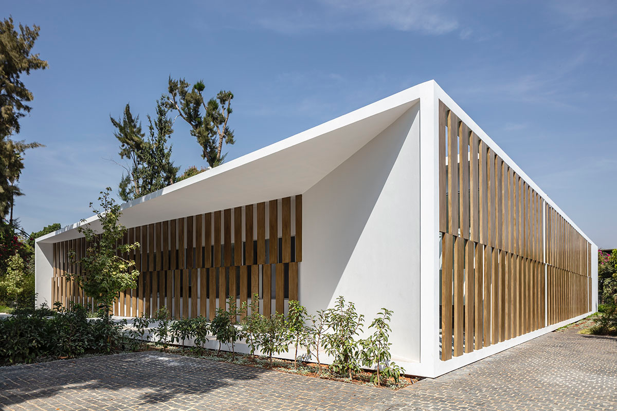 Large sunken yard defines the program of Split House designed by Pitsou Kedem Architects in Israel