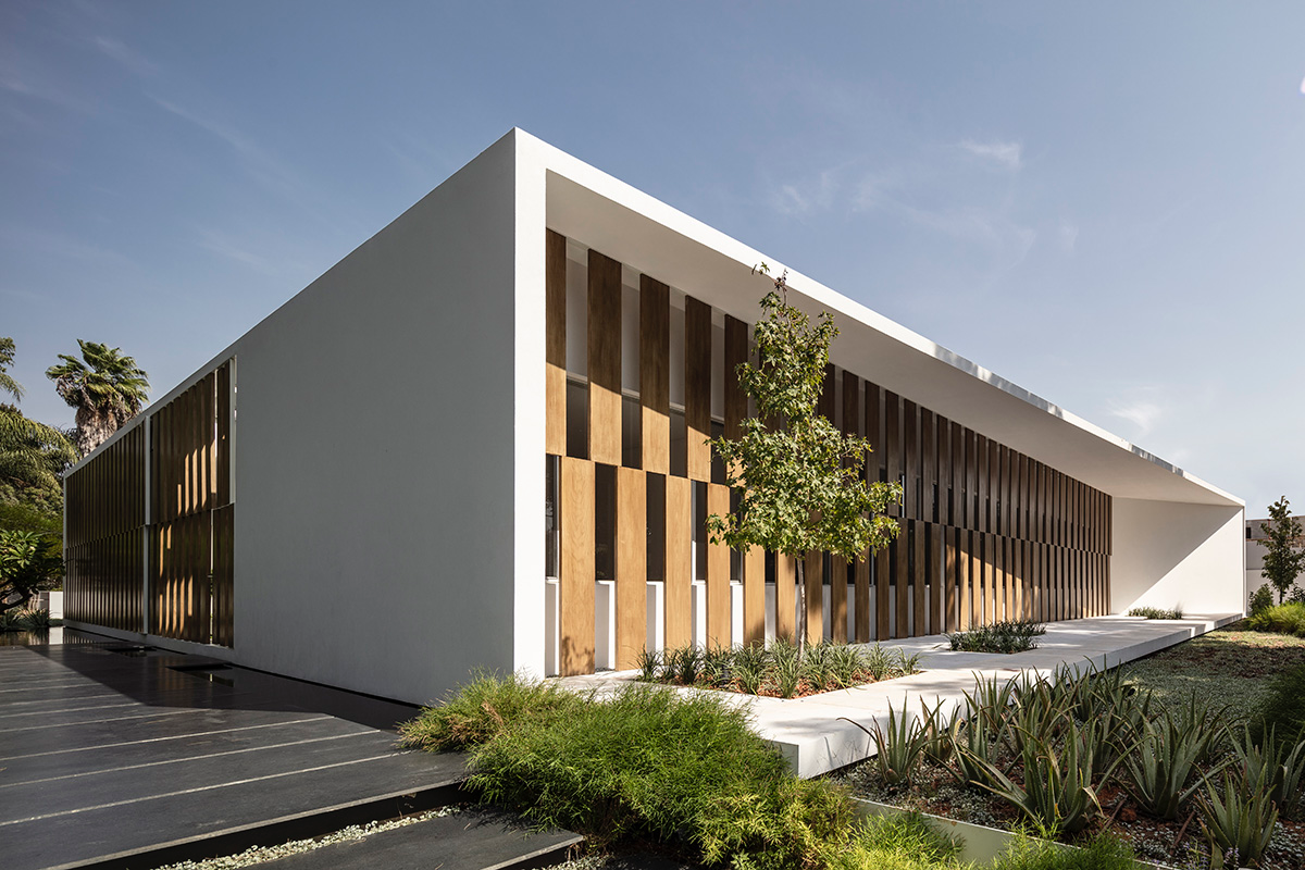 Large sunken yard defines the program of Split House designed by Pitsou Kedem Architects in Israel